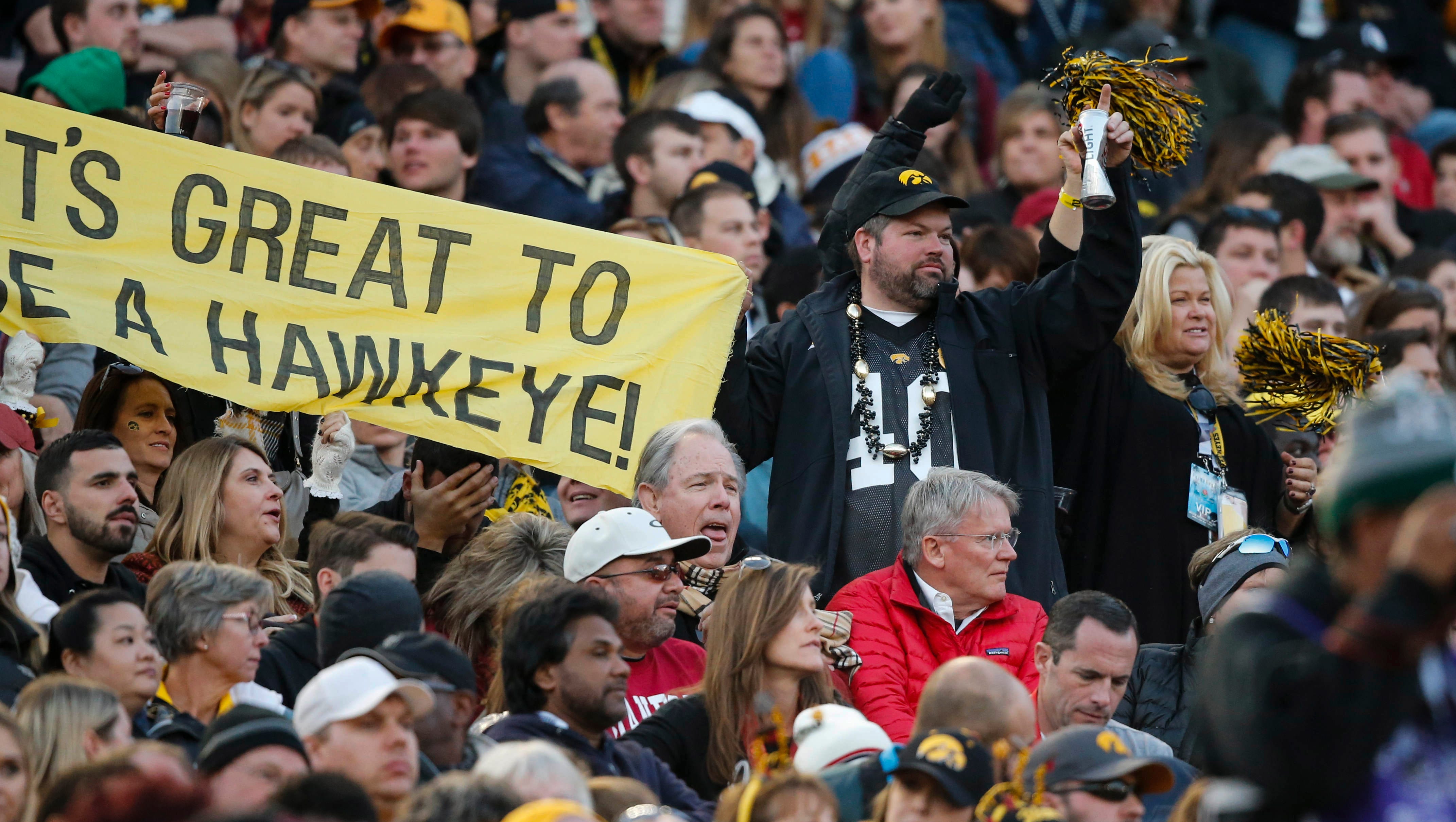 A Hawkeye fan holds up a sign despite the Hawkeyes' lopsided score to Stanford to start the third quarter on Friday, Jan. 1, 2016, at the Rose Bowl in Pasadena, Calif.