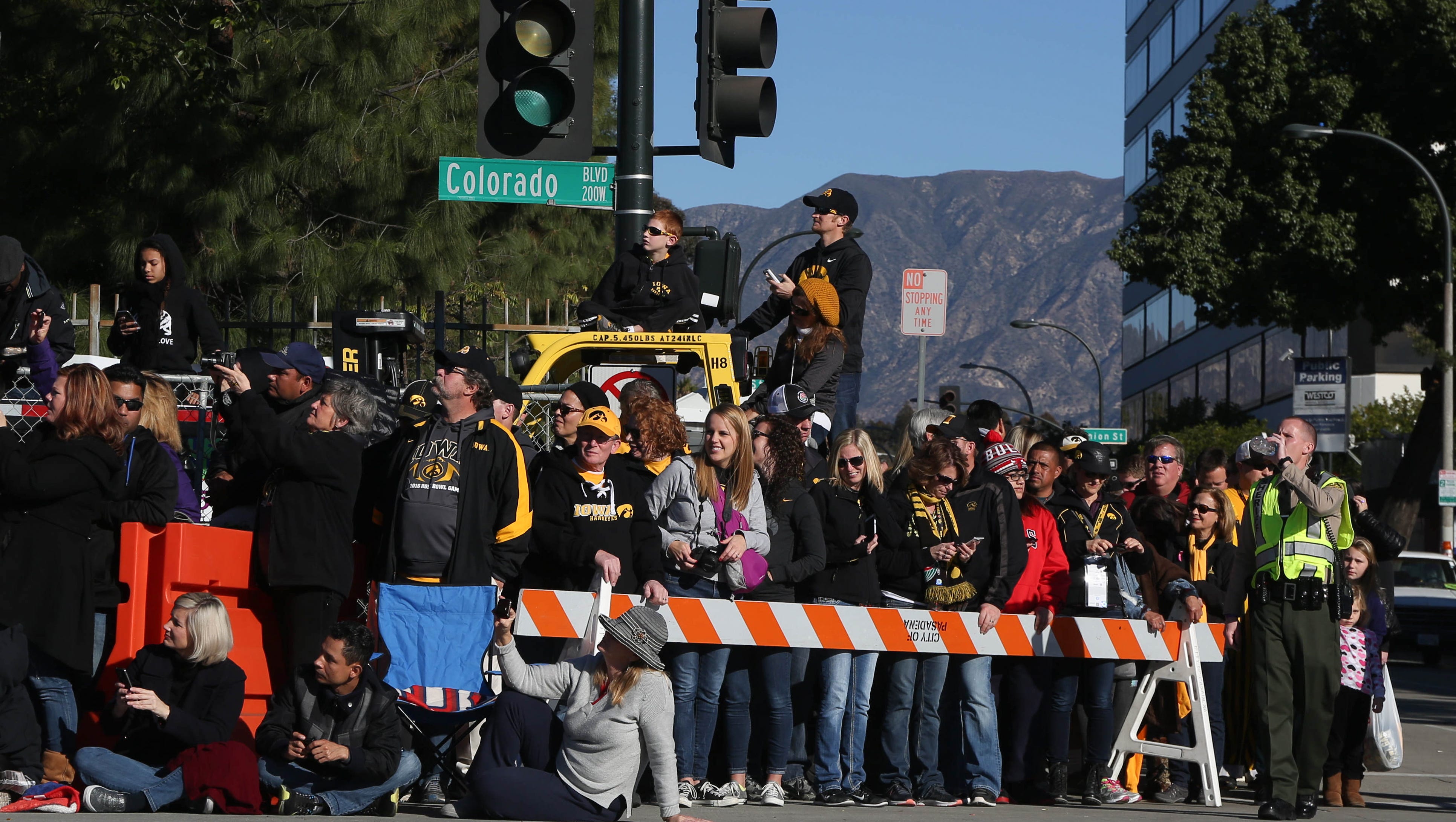 Iowa fans line up along Colorado Blvd. on Friday, Jan. 1, 2016, during the 2016 Tournament of Roses Parade in Pasadena, Calif.