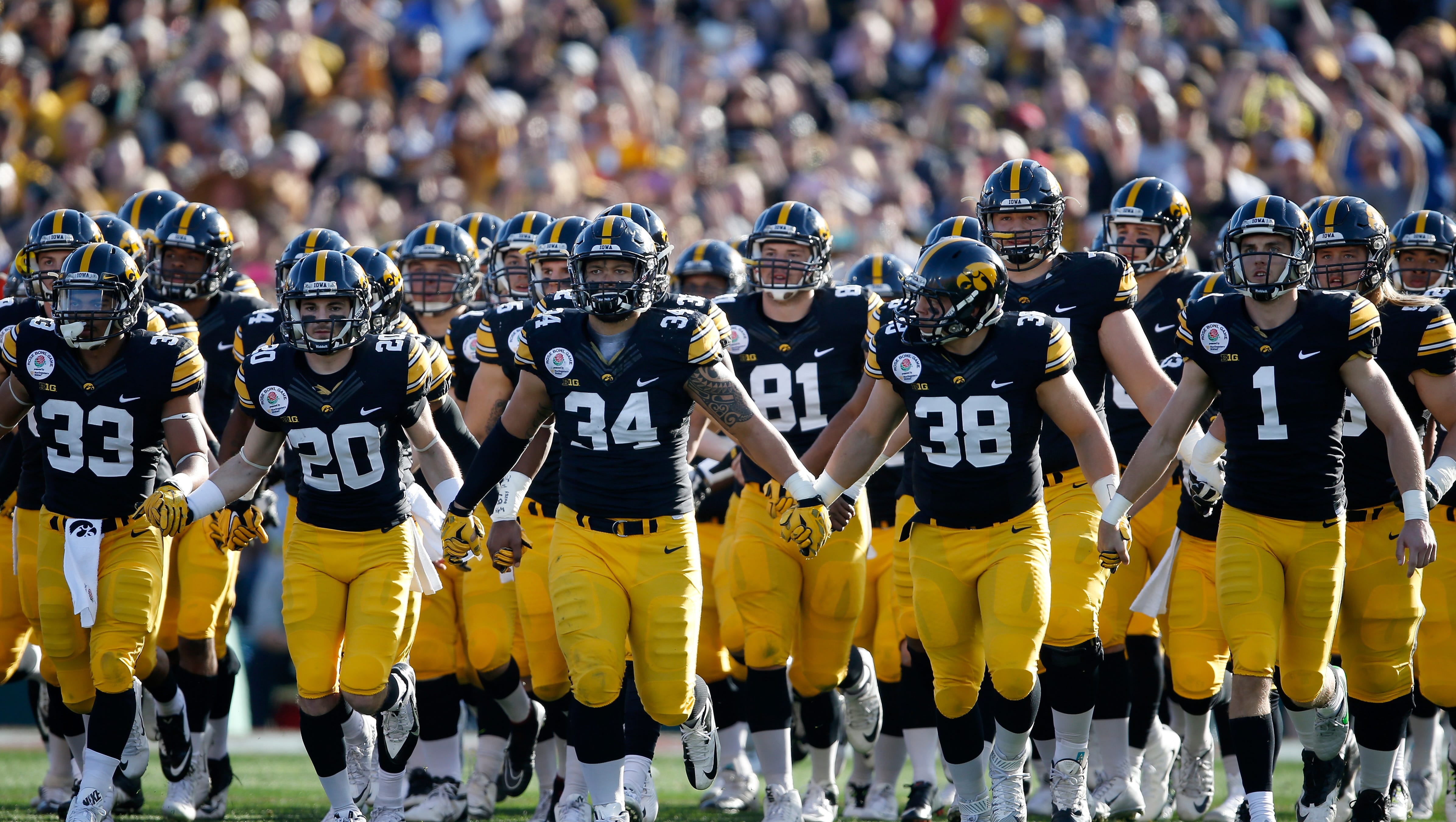 The Iowa Hawkeyes walk onto the field to face the Stanford Cardinal in the 102nd Rose Bowl Game on January 1, 2016 at the Rose Bowl in Pasadena, California.