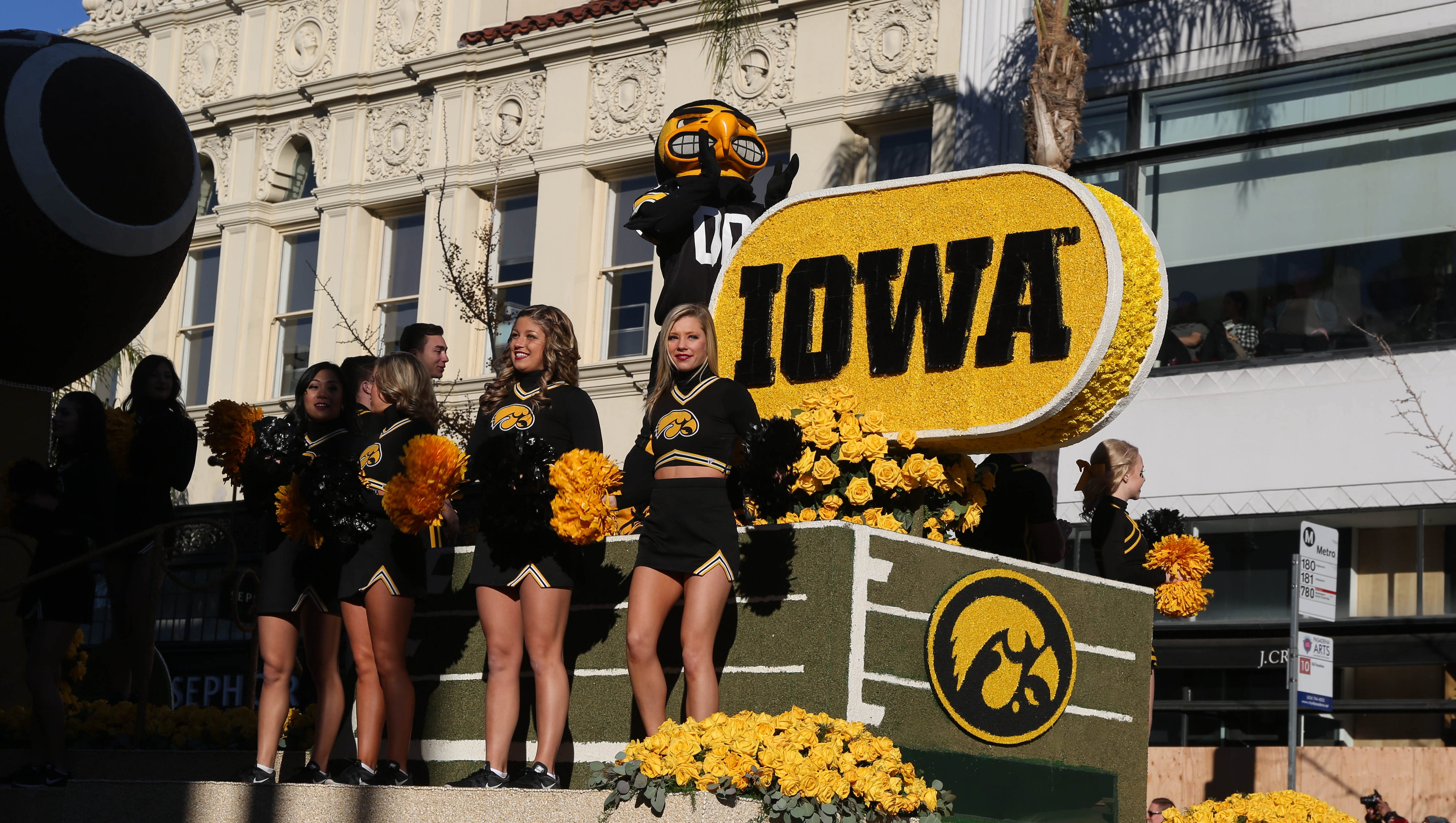 Members of the University of Iowa Spirit Squad greet Hawkeye supporters lined up along Colorado Blvd. on Friday, Jan. 1, 2016, during the 2016 Tournament of Roses Parade in Pasadena, Calif.