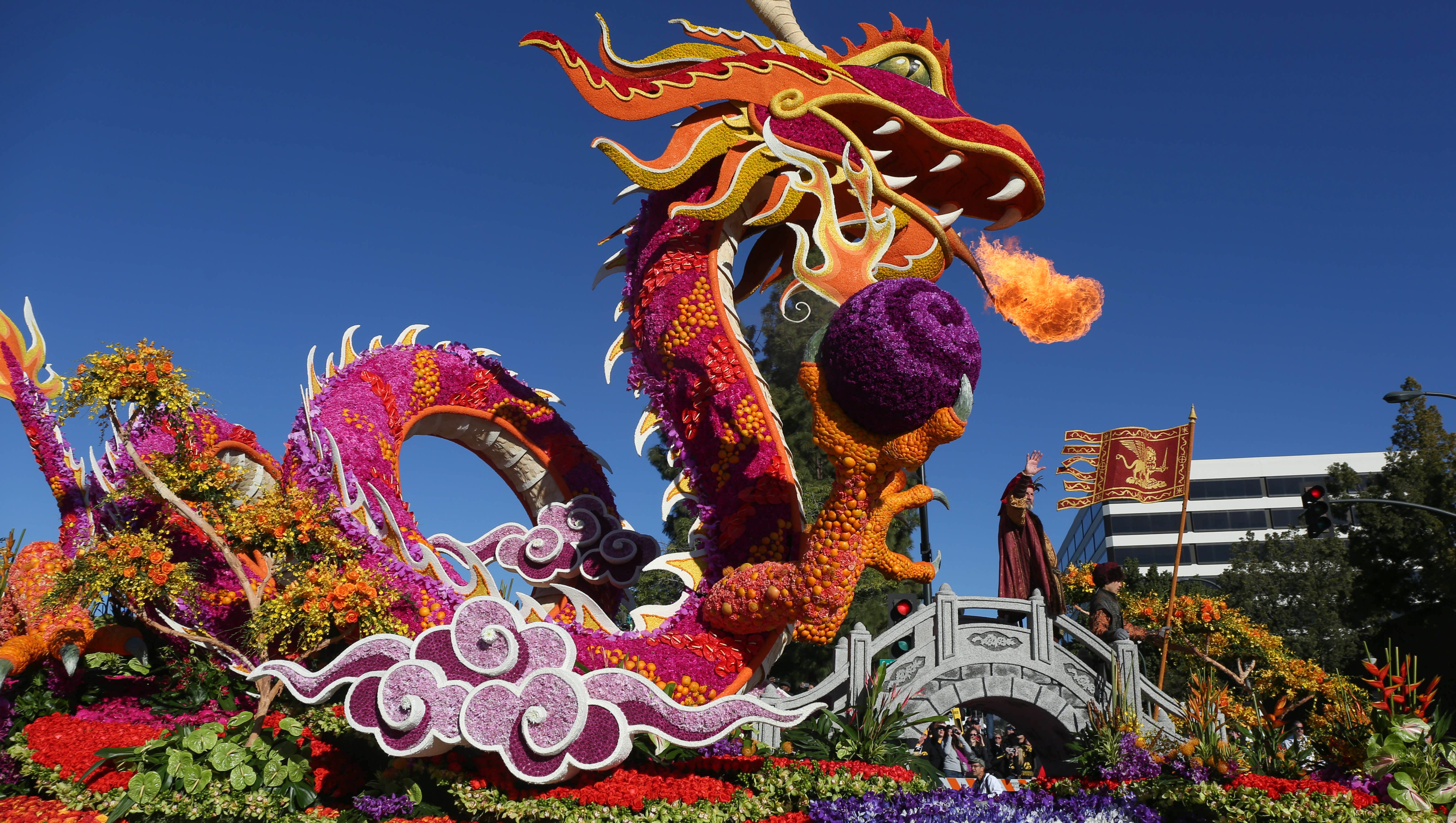 A dragon float breathes fire on Friday, Jan. 1, 2016, during the 2016 Tournament of Roses Parade in Pasadena, Calif.