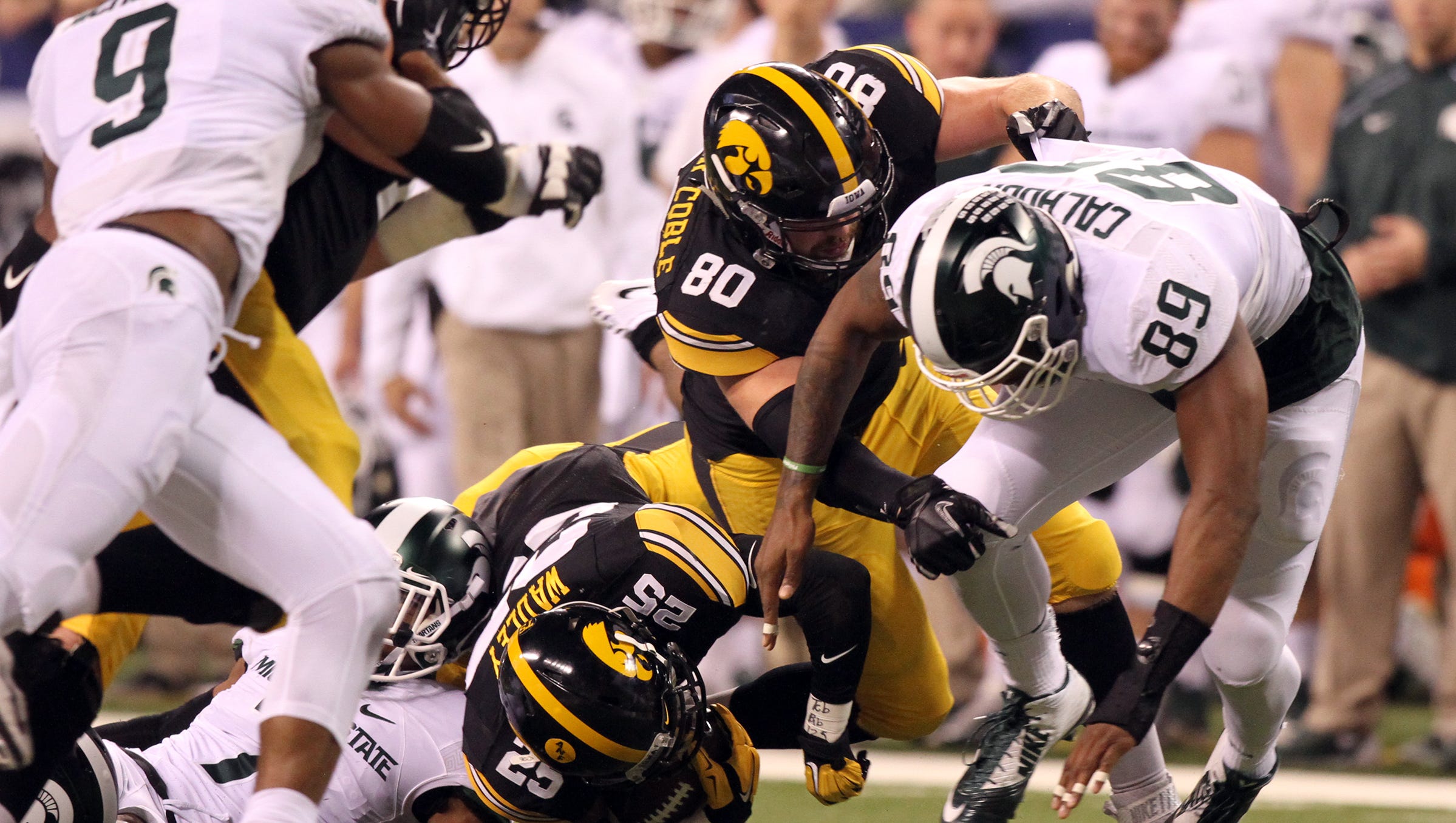 Iowa running back Akrum Wadley gets brought down during the Hawkeyes' Big Ten Championship game against Michigan State at Lucas Oil Stadium in Indianapolis, Ind. on Saturday, Dec. 5, 2015.