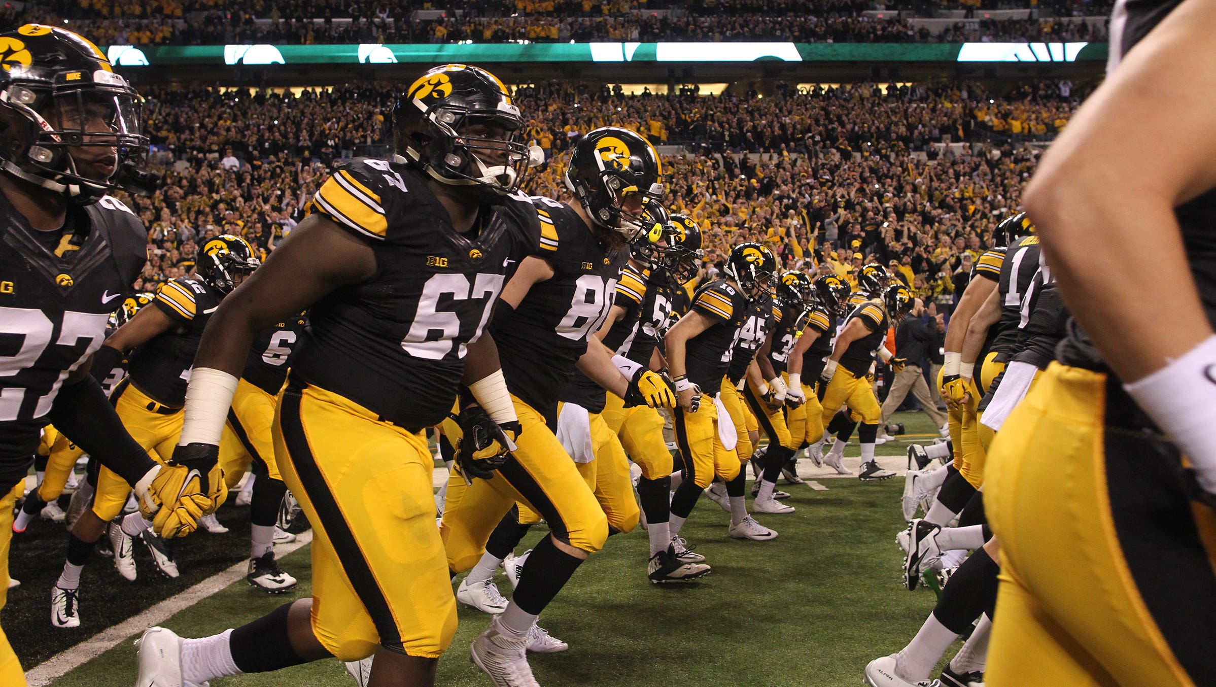 Iowa takes the field for the Big Ten Championship game against Michigan State at Lucas Oil Stadium in Indianapolis, Ind. on Saturday, Dec. 5, 2015.