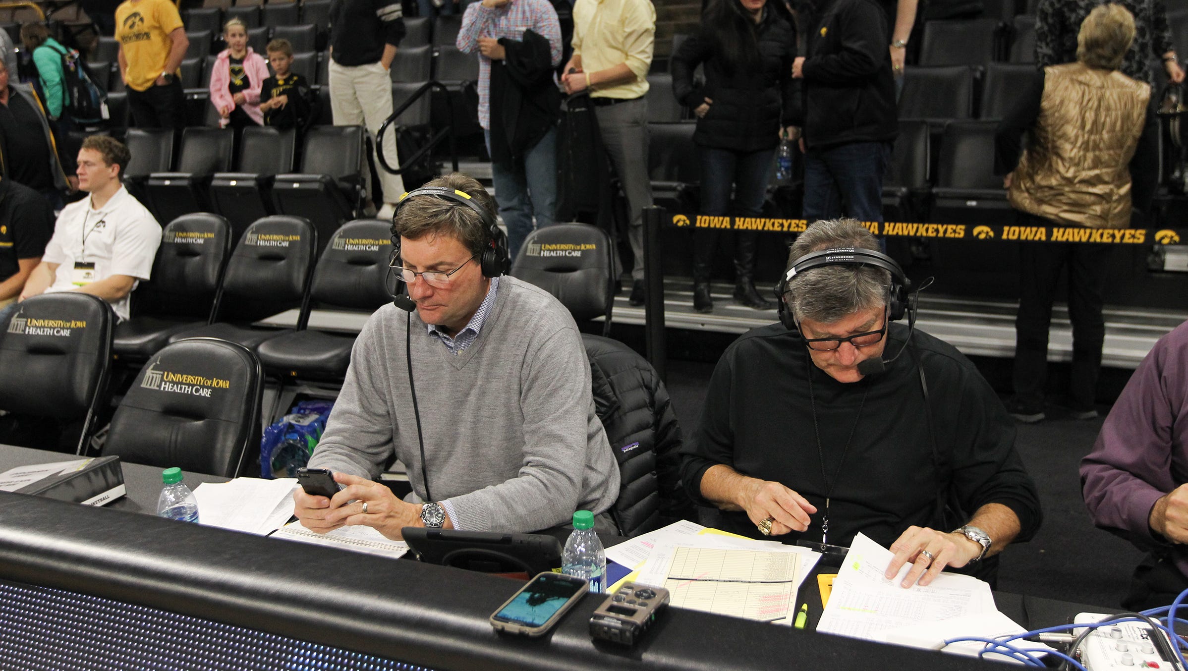 Bobby Hansen, left, and Gary Dolphin flip through notes after the Hawkeyes' game against Stetson at Carver-Hawkeye Arena on Monday, Dec. 5, 2016.