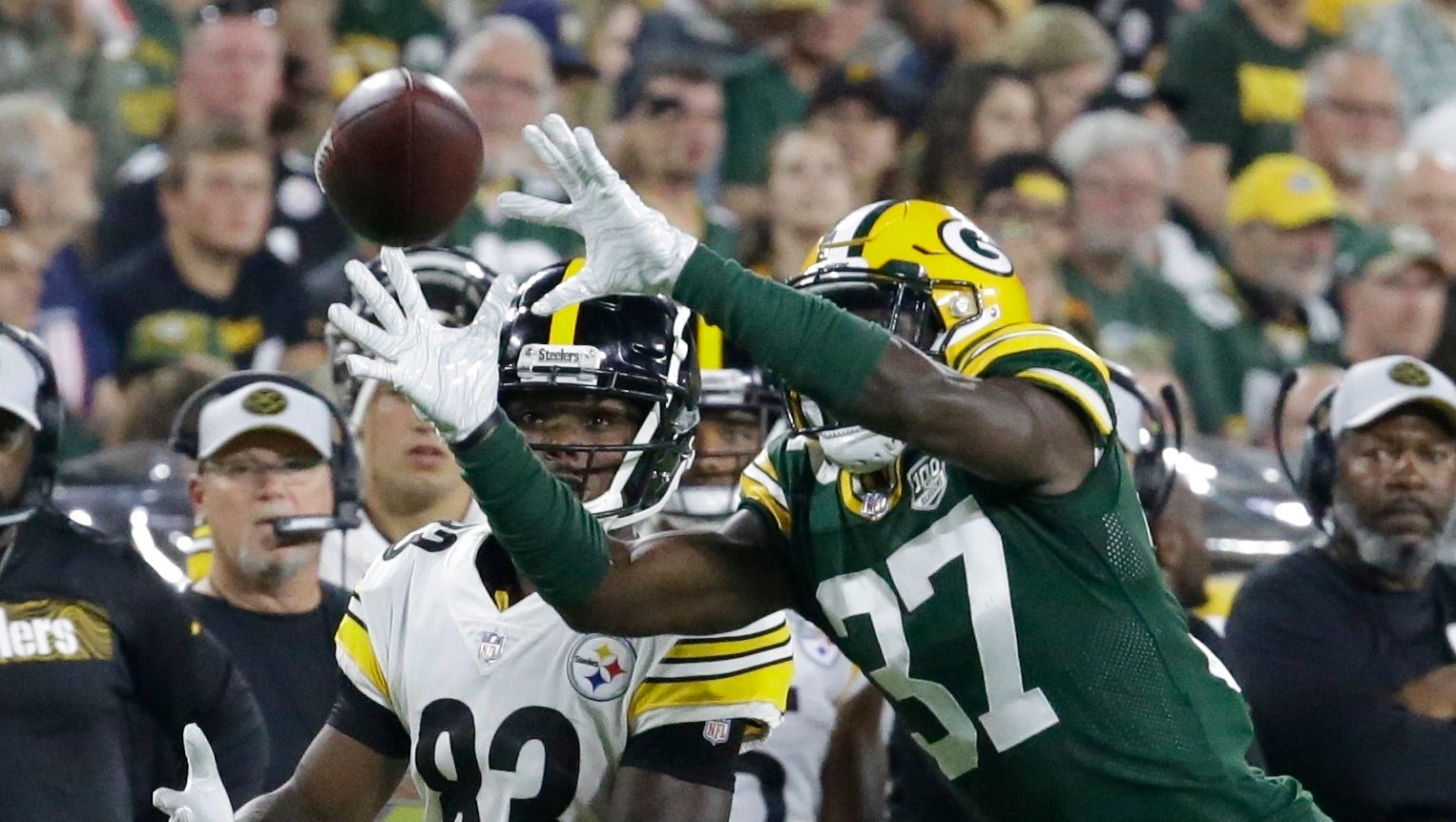 Green Bay Packers' Josh Jackson intercepts a pass in front of Pittsburgh Steelers' Damoun Patterson and returns it for a touchdown during the second half of a preseason NFL football game Thursday, Aug. 16, 2018, in Green Bay, Wis.