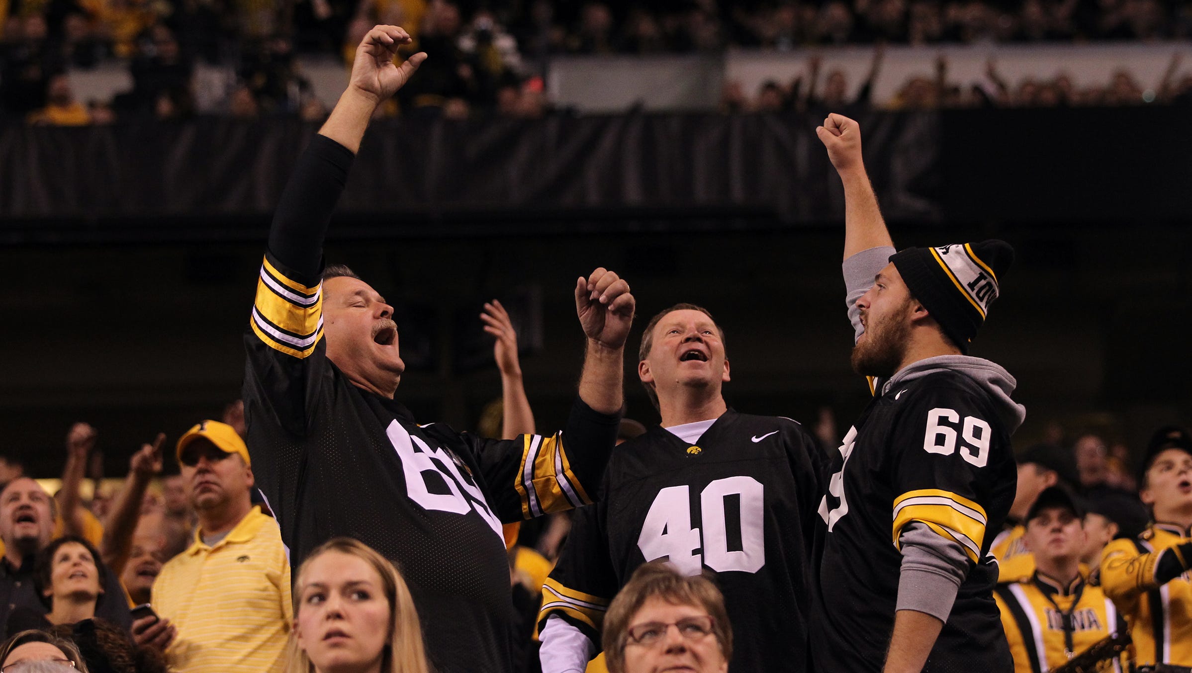 Iowa fans celebrate a reversed call during the Hawkeyes' Big Ten Championship game against Michigan State at Lucas Oil Stadium in Indianapolis, Ind. on Saturday, Dec. 5, 2015.