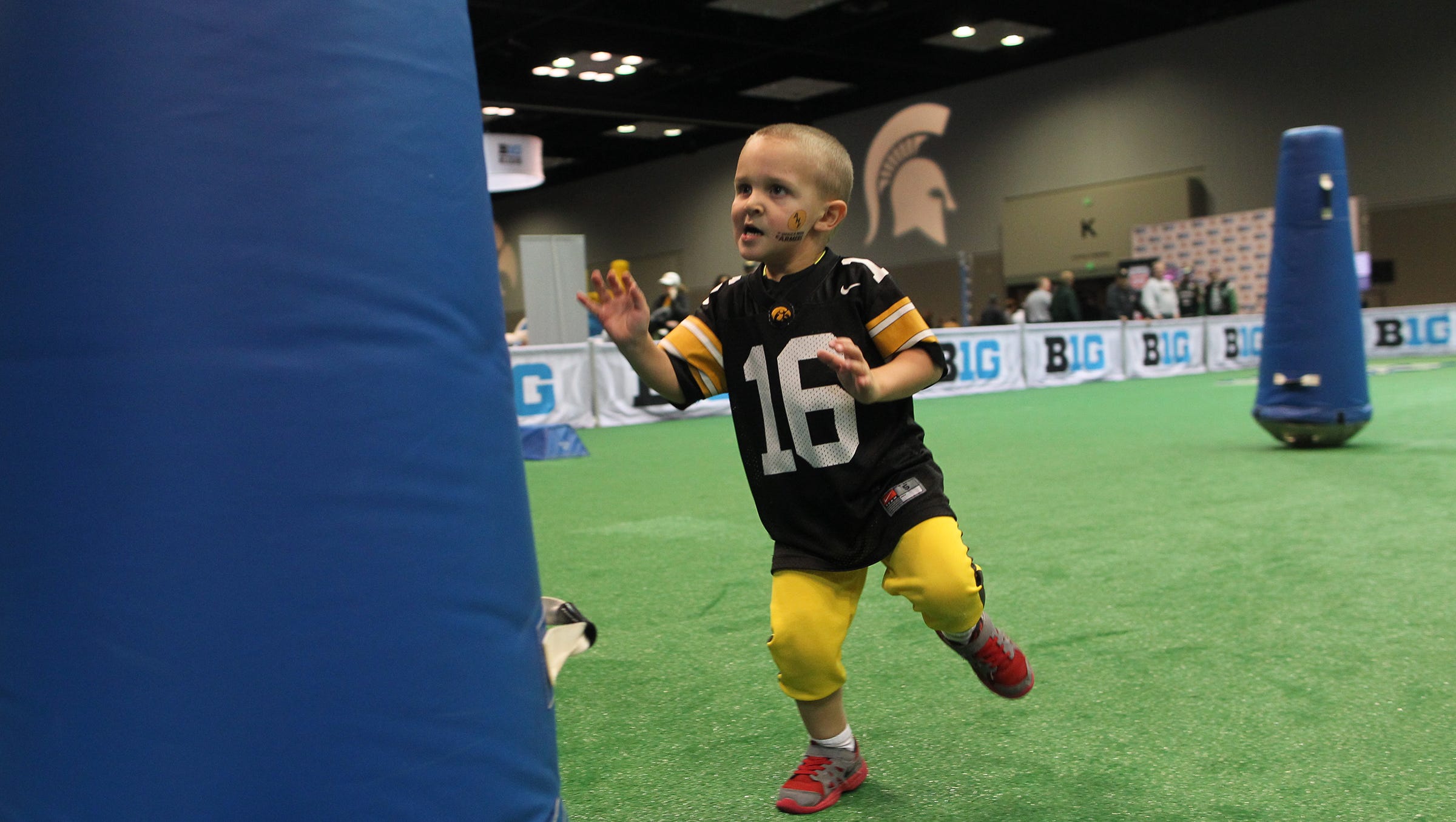 Kade Wagemester, 3, of Long Grove runs through a football obstacle course at the Indiana Convention Center in Indianapolis, Ind. on Saturday, Dec. 5, 2015.