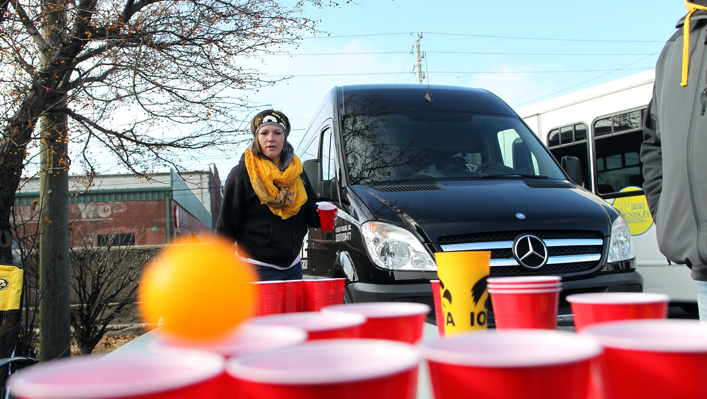 Samantha Pacha of Davenport plays beer pong with friends prior to the Hawkeyes' Big Ten Championship game against Michigan State at Lucas Oil Stadium in Indianapolis, Ind. on Saturday, Dec. 5, 2015.