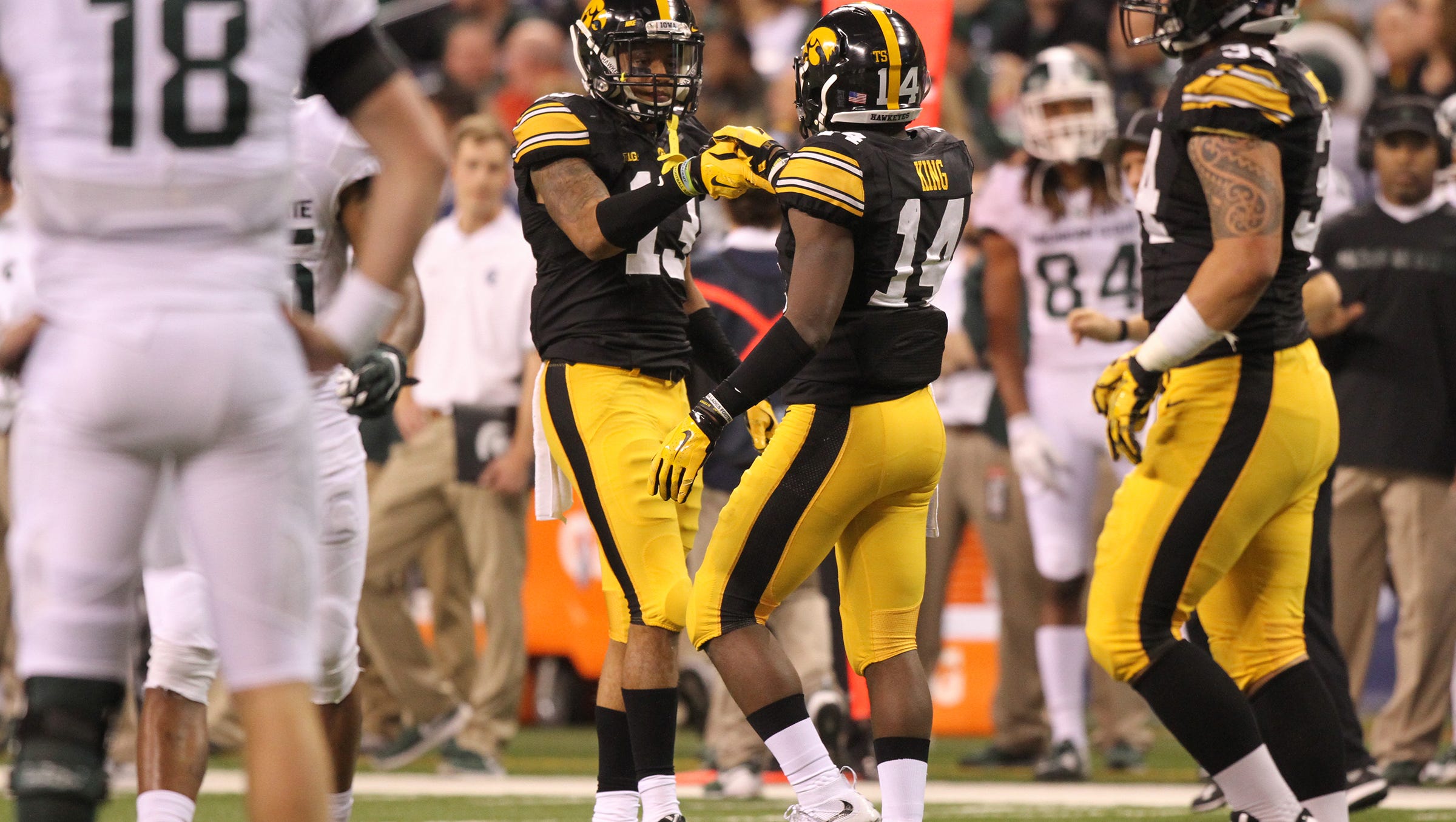 Iowa's Greg Mabin, left, and Desmond King celebrate a stop during the Hawkeyes' Big Ten Championship game against Michigan State at Lucas Oil Stadium in Indianapolis, Ind. on Saturday, Dec. 5, 2015.