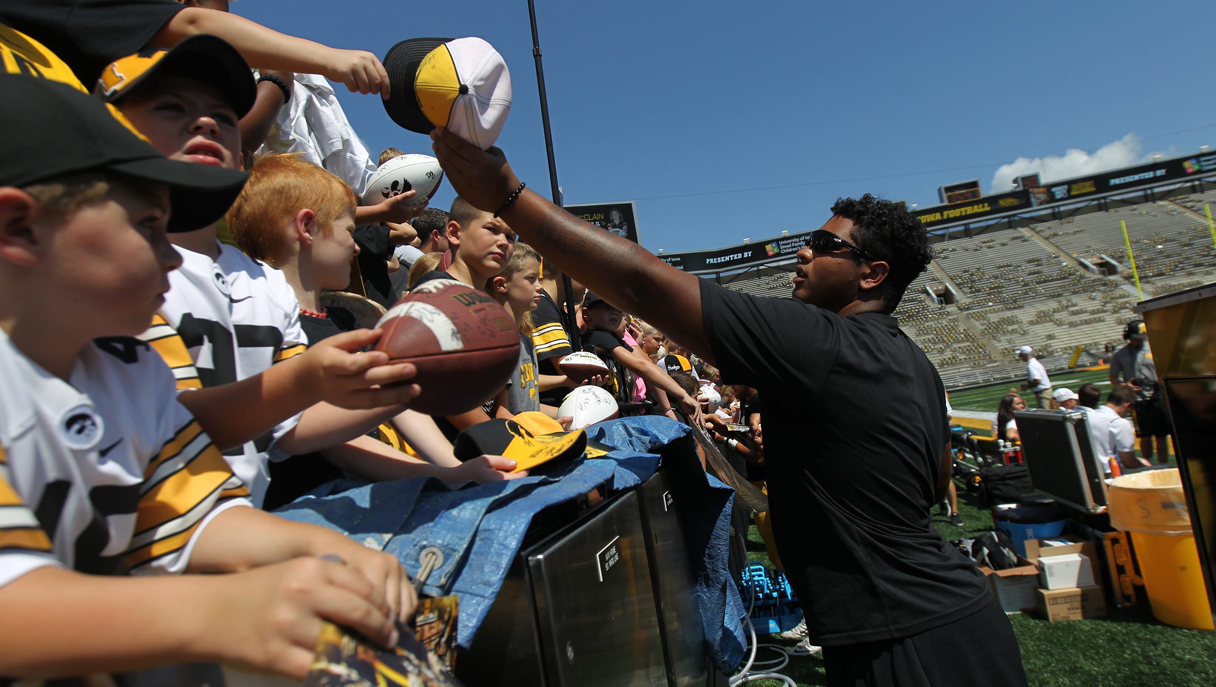 Iowa's Tristan Wirfs signs autographs during the open practice on Kids Day at Kinnick Stadium on Saturday, Aug. 12, 2017.