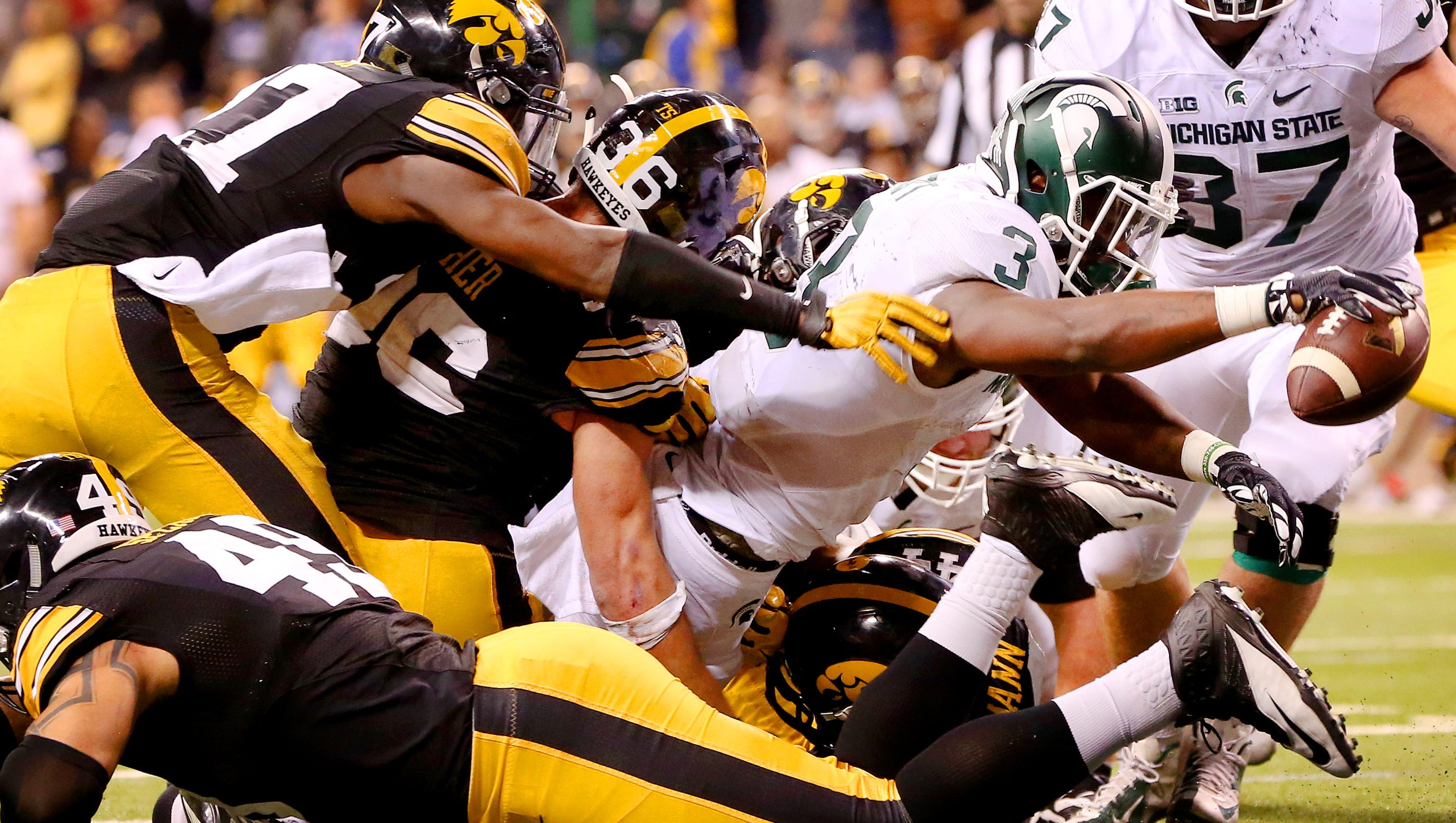 Michigan State running back LJ Scott (3) reaches across the goal line for the go ahead touchdown against Iowa during the Big Ten Championship Game at Lucas Oil Stadium on Dec. 5, 2015.