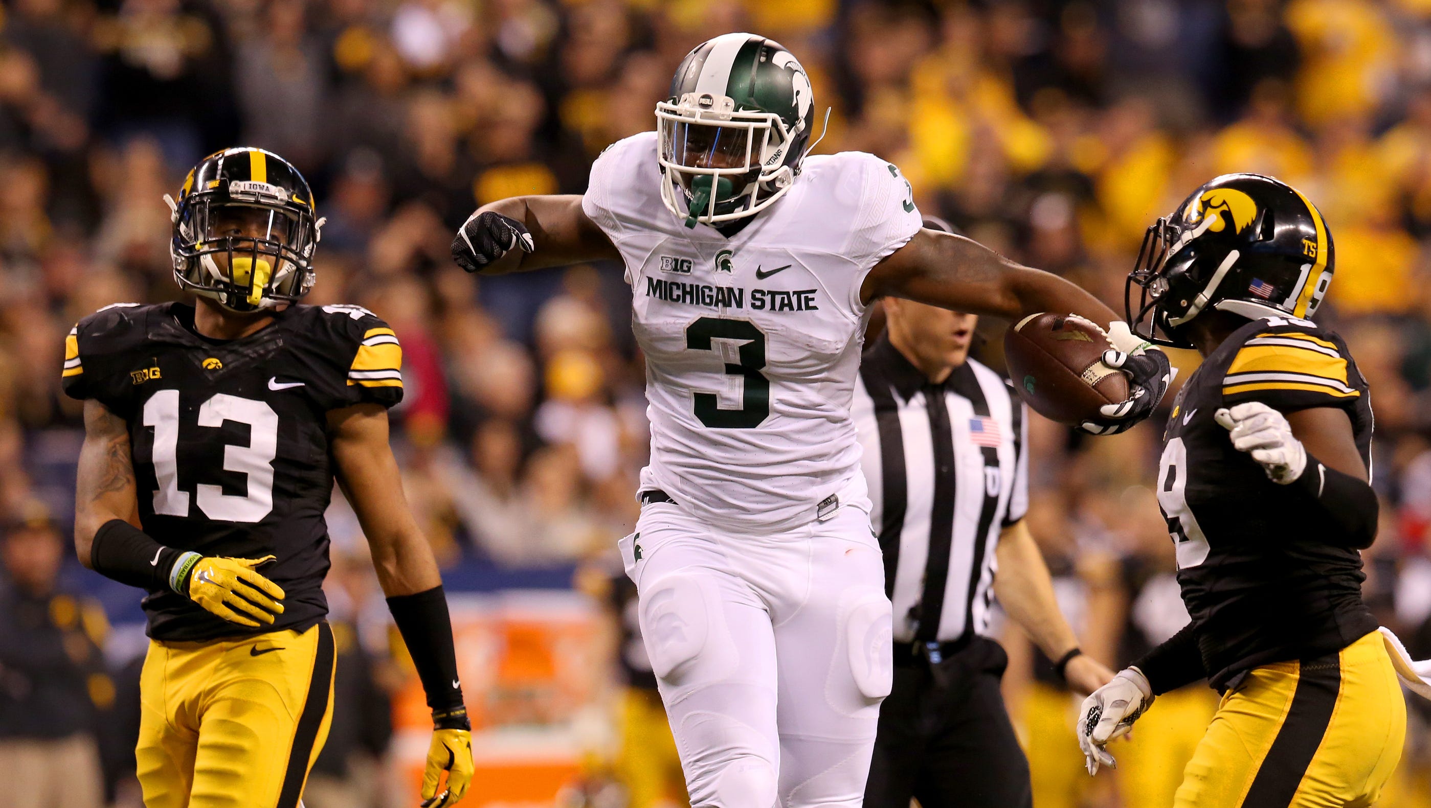 Michigan State running back LJ Scott (3) shows his excitement after getting a first down against Iowa during the Big Ten Championship Game at Lucas Oil Stadium on Dec. 5, 2015.