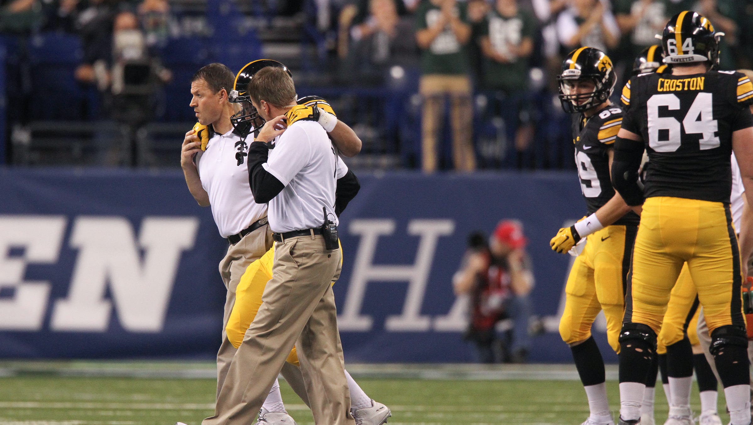 Iowa staff helps running back Jordan Canzeri off the field during the Hawkeyes' Big Ten Championship game against Michigan State at Lucas Oil Stadium in Indianapolis, Ind. on Saturday, Dec. 5, 2015.