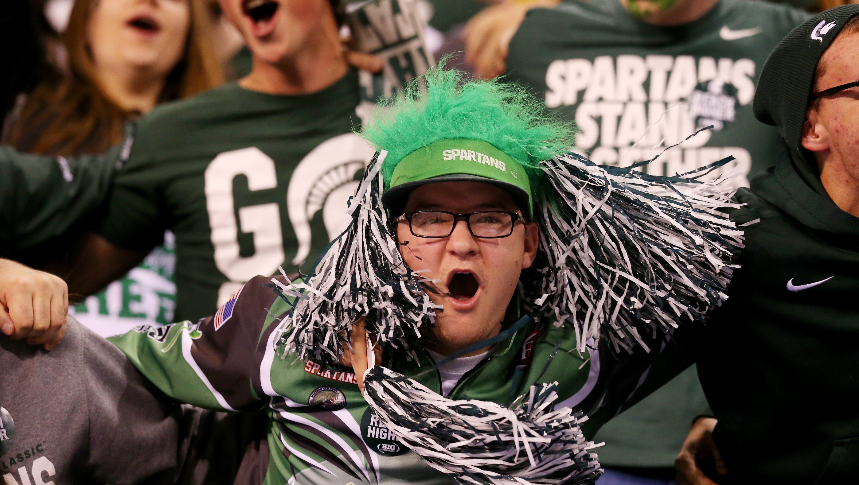 A Michigan State fan gets excited as the team enters the field during the Big Ten Championship Game at Lucas Oil Stadium on Dec. 5, 2015.
