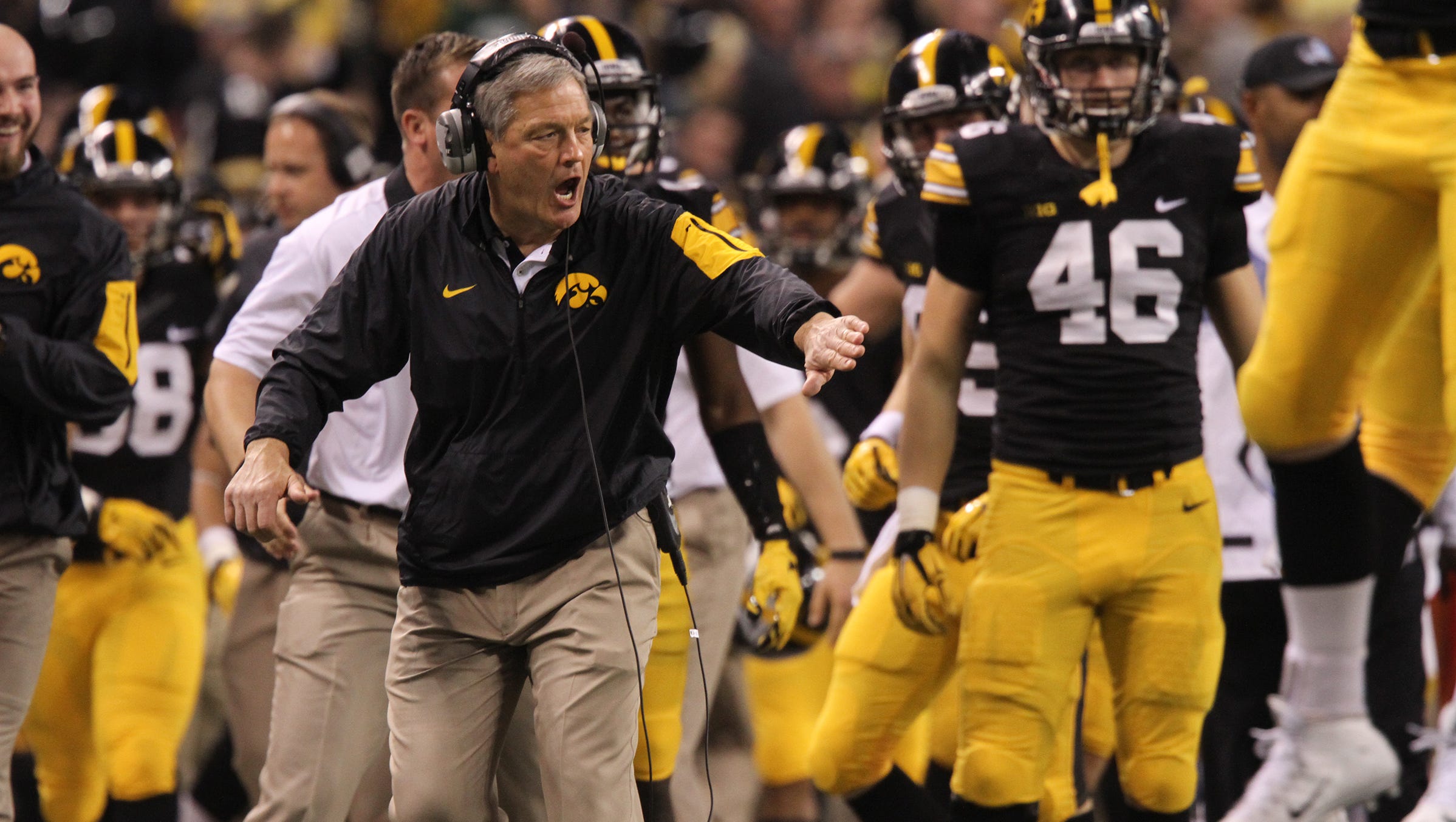 Iowa head coach Kirk Ferentz high-five's players after a fumble recovery during the Hawkeyes' Big Ten Championship game against Michigan State at Lucas Oil Stadium in Indianapolis, Ind. on Saturday, Dec. 5, 2015.