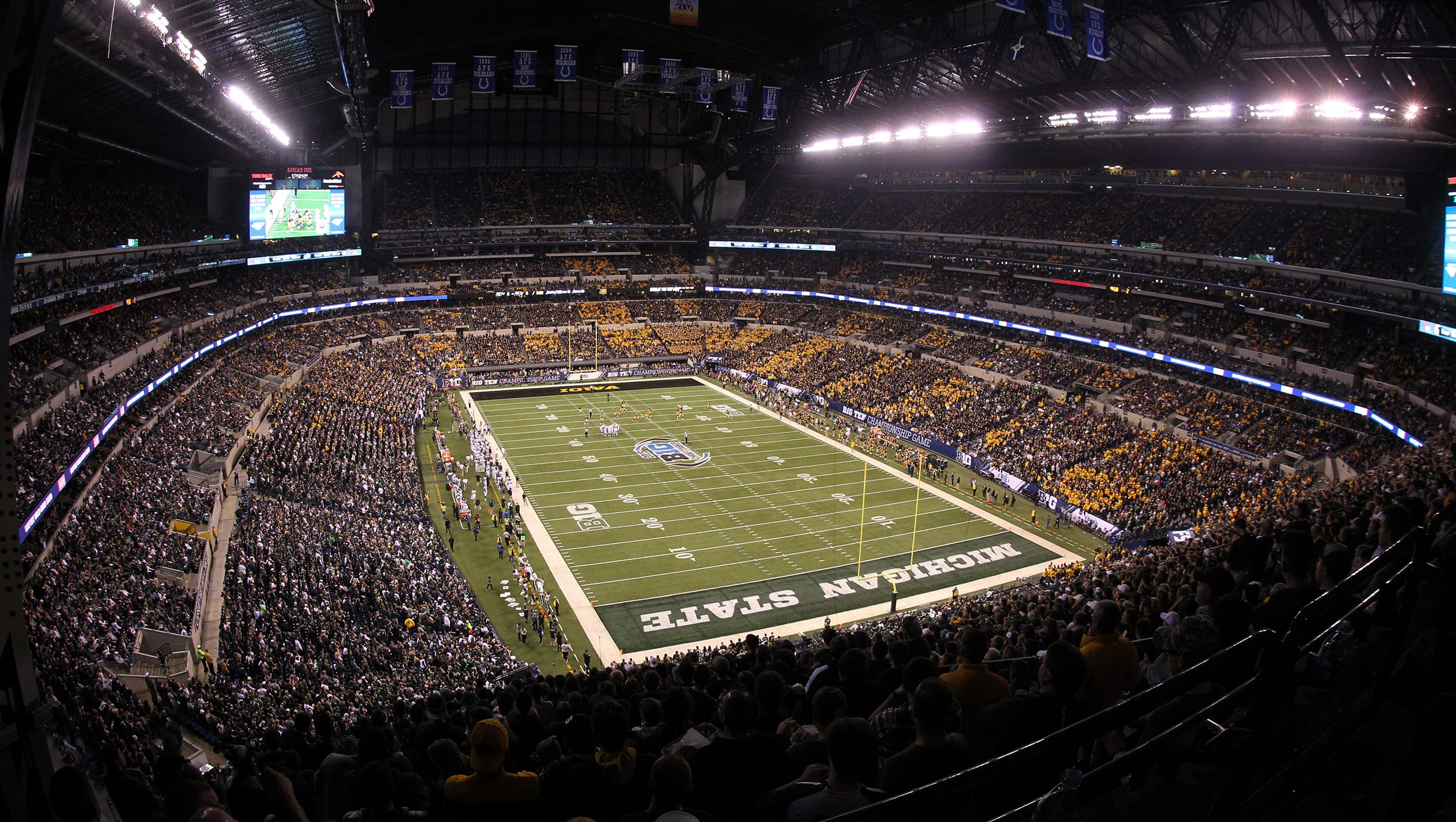 Football fans watch the Big Ten Championship game between Iowa and Michigan State at Lucas Oil Stadium in Indianapolis, Ind. on Saturday, Dec. 5, 2015.