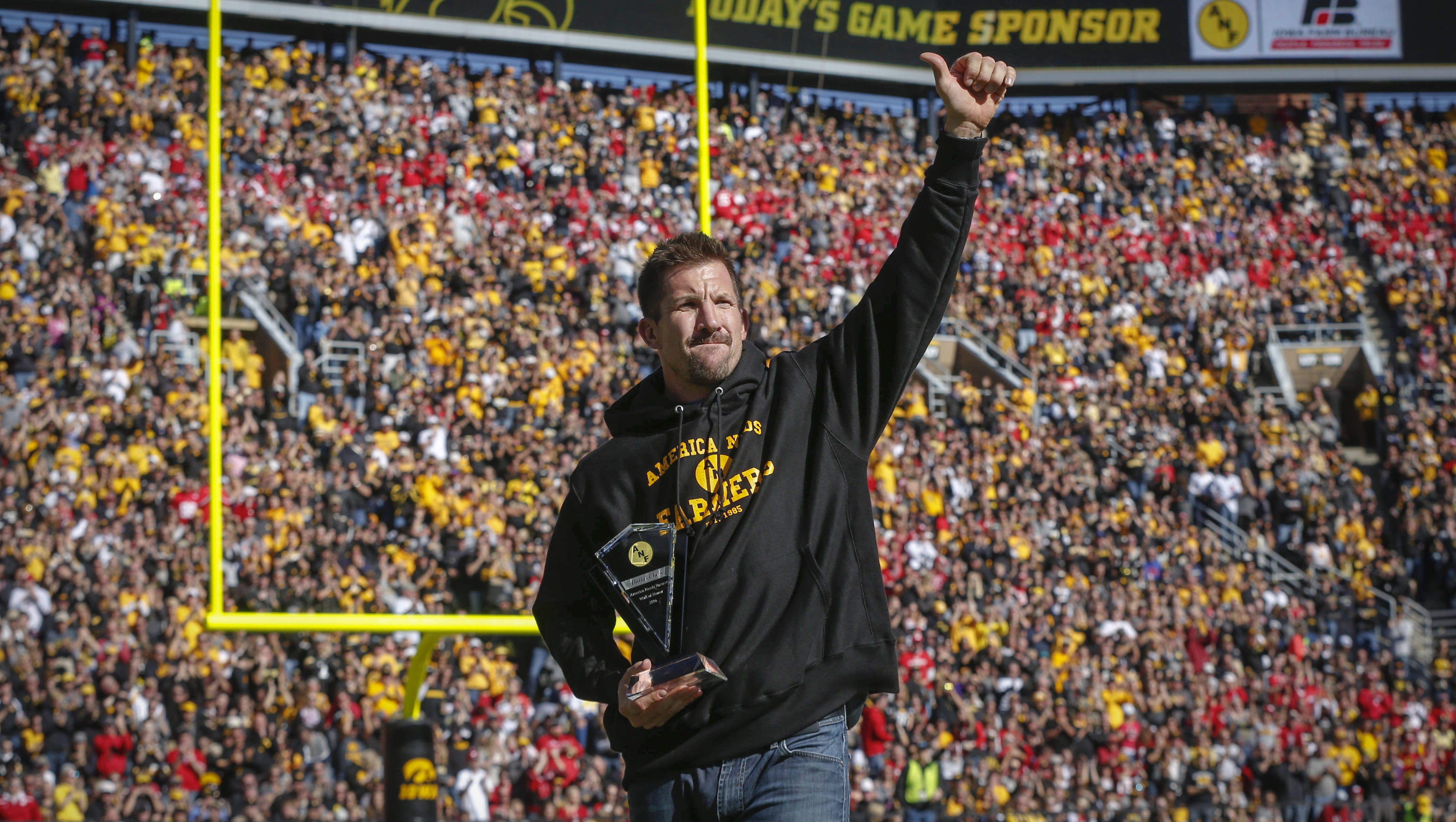 Former Hawkeye and NFL tight end Dallas Clark received the America Needs Farmers Wall of Honor trophy during a break in action against Wisconsin on Saturday, Oct. 22, 2016, at Kinnick Stadium in Iowa City.