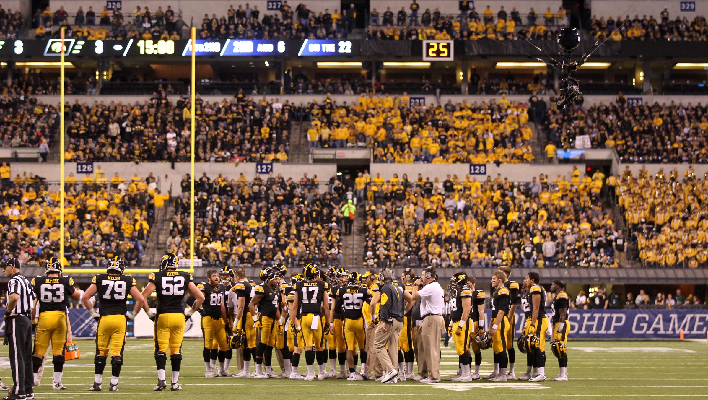 Iowa teammates huddle during a timeout from the Big Ten Championship game against Michigan State at Lucas Oil Stadium in Indianapolis, Ind. on Saturday, Dec. 5, 2015.