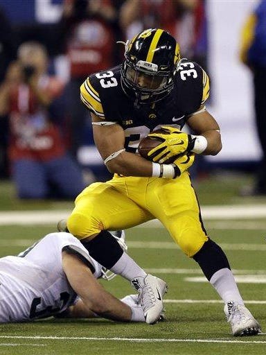 Iowa running back Jordan Canzeri (33) cuts up field against Michigan State during the first half of the Big Ten Conference championship NCAA college football game Saturday, Dec. 5, 2015, in Indianapolis. (AP Photo/Michael Conroy)