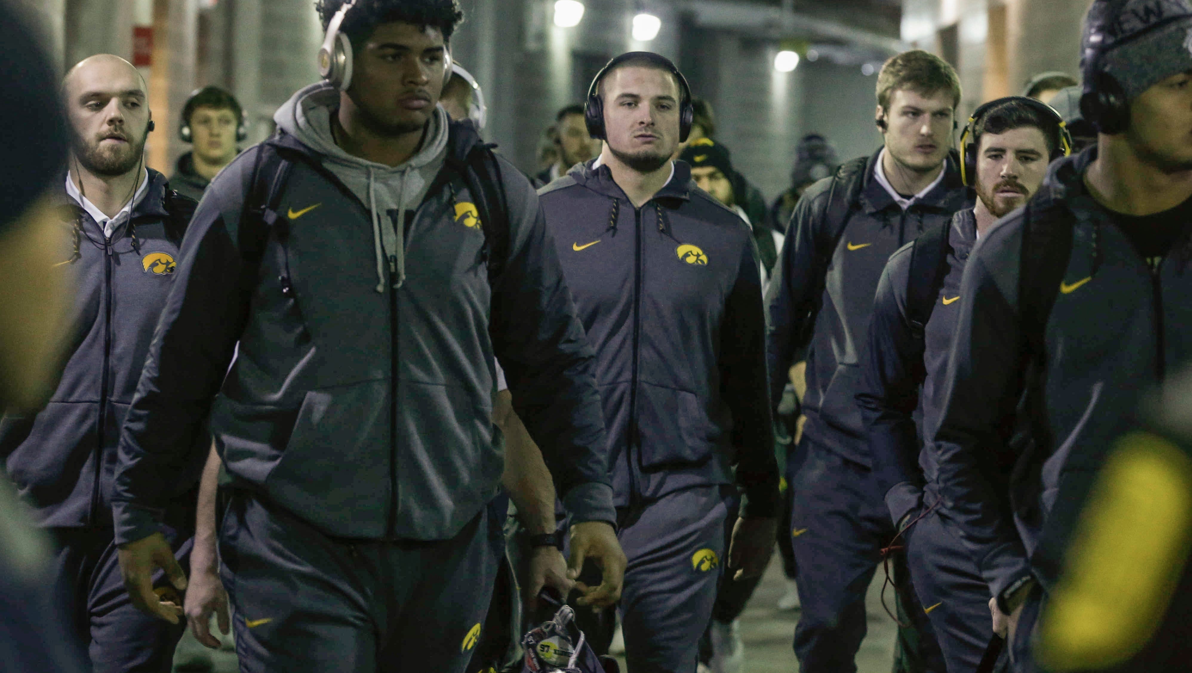 Iowa right tackle Tristan Wirfs, left, and the Hawkeyes make their way to the team locker room prior to kickoff against Boston College during the 2017 Pinstripe Bowl at Yankee Stadium in Bronx, New York on Wednesday, Dec. 27, 2017.