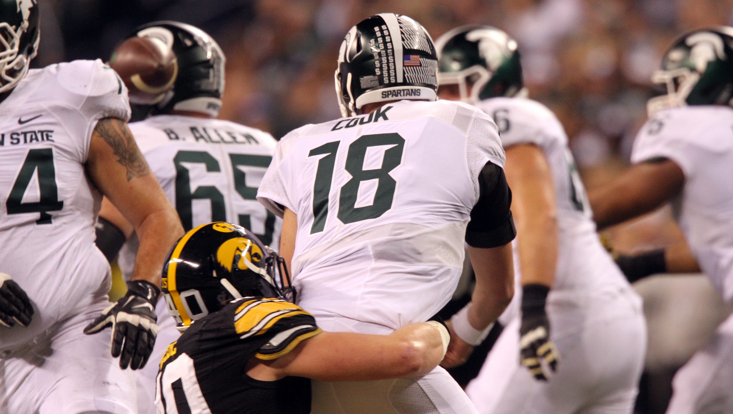 Iowa's Parker Hesse forces a fumble from Michigan State quarterback Connor Cook during the Big Ten Championship game at Lucas Oil Stadium in Indianapolis, Ind. on Saturday, Dec. 5, 2015.