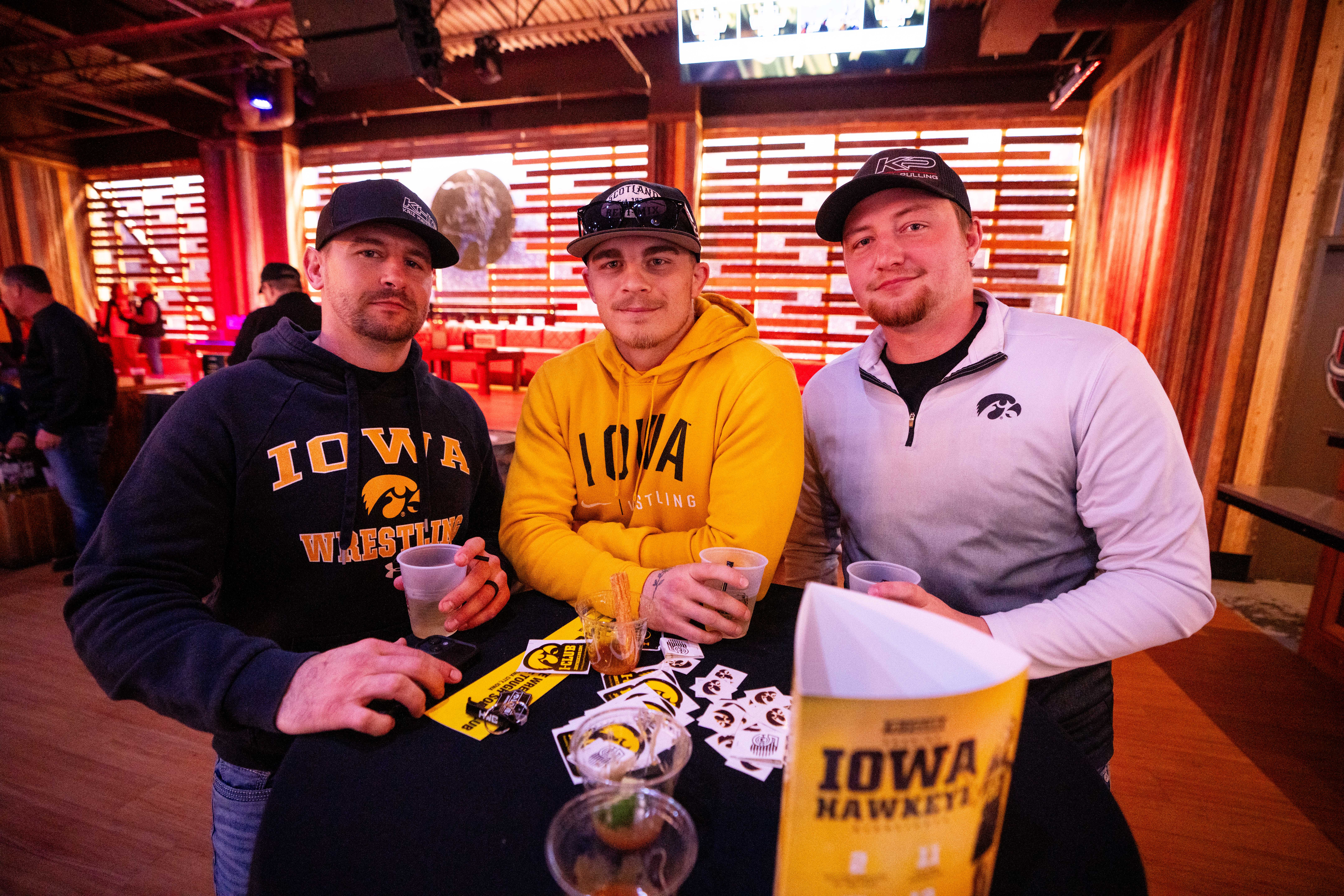 Darren Kriz, Alex Caba and Dommonick Pechous of South Dakota, attend the Hawkeye Huddle ahead of the NCAA championship semi final round Friday, March 22, 2024, at the Power and Light District in Kansas City, Missouri.