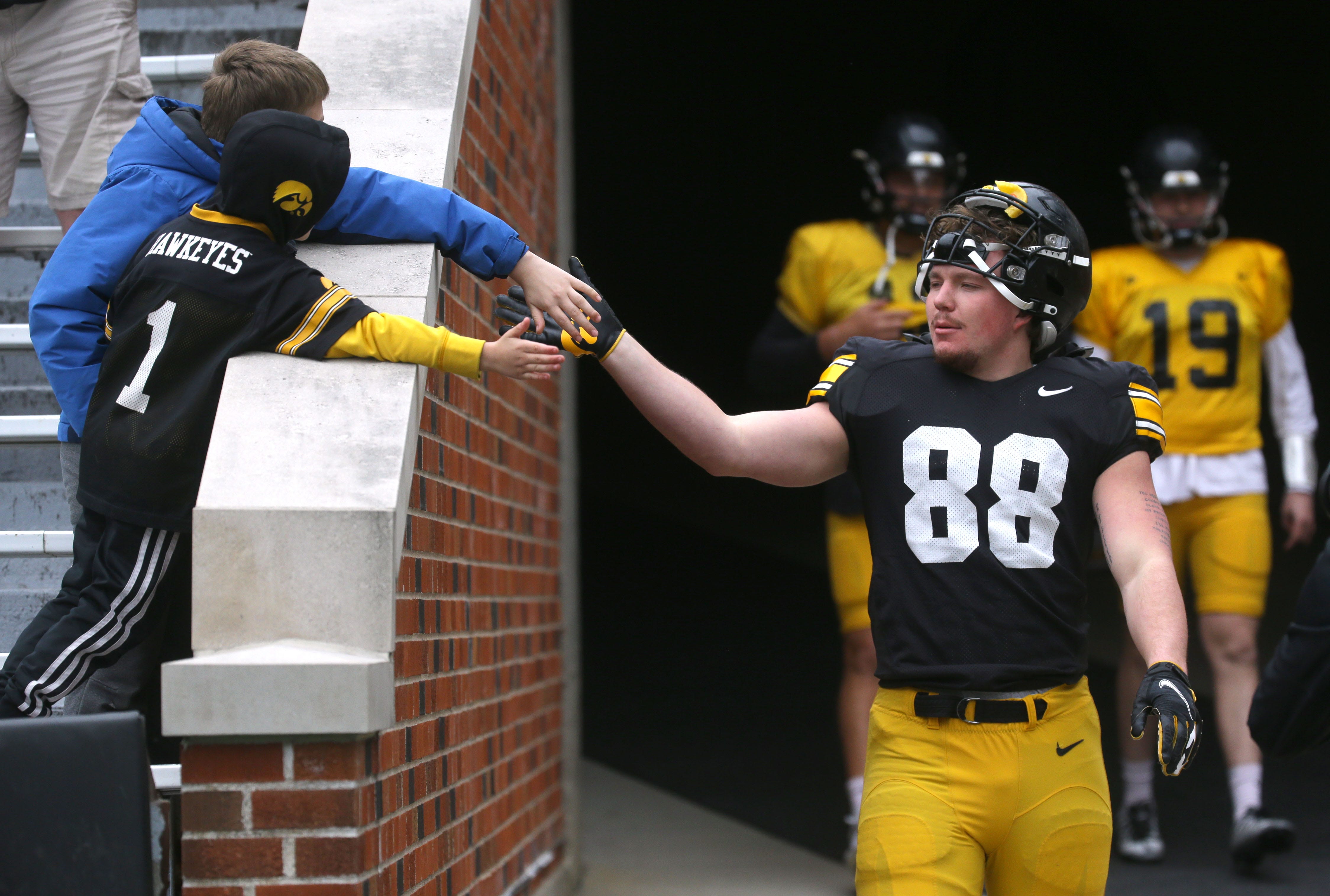 Iowa Hawkeyes fullback Hayden Large (88) high-fives fans while walking out of the tunnel during an open spring practice Saturday, April 20, 2024 at Kinnick Stadium in Iowa City, Iowa.
