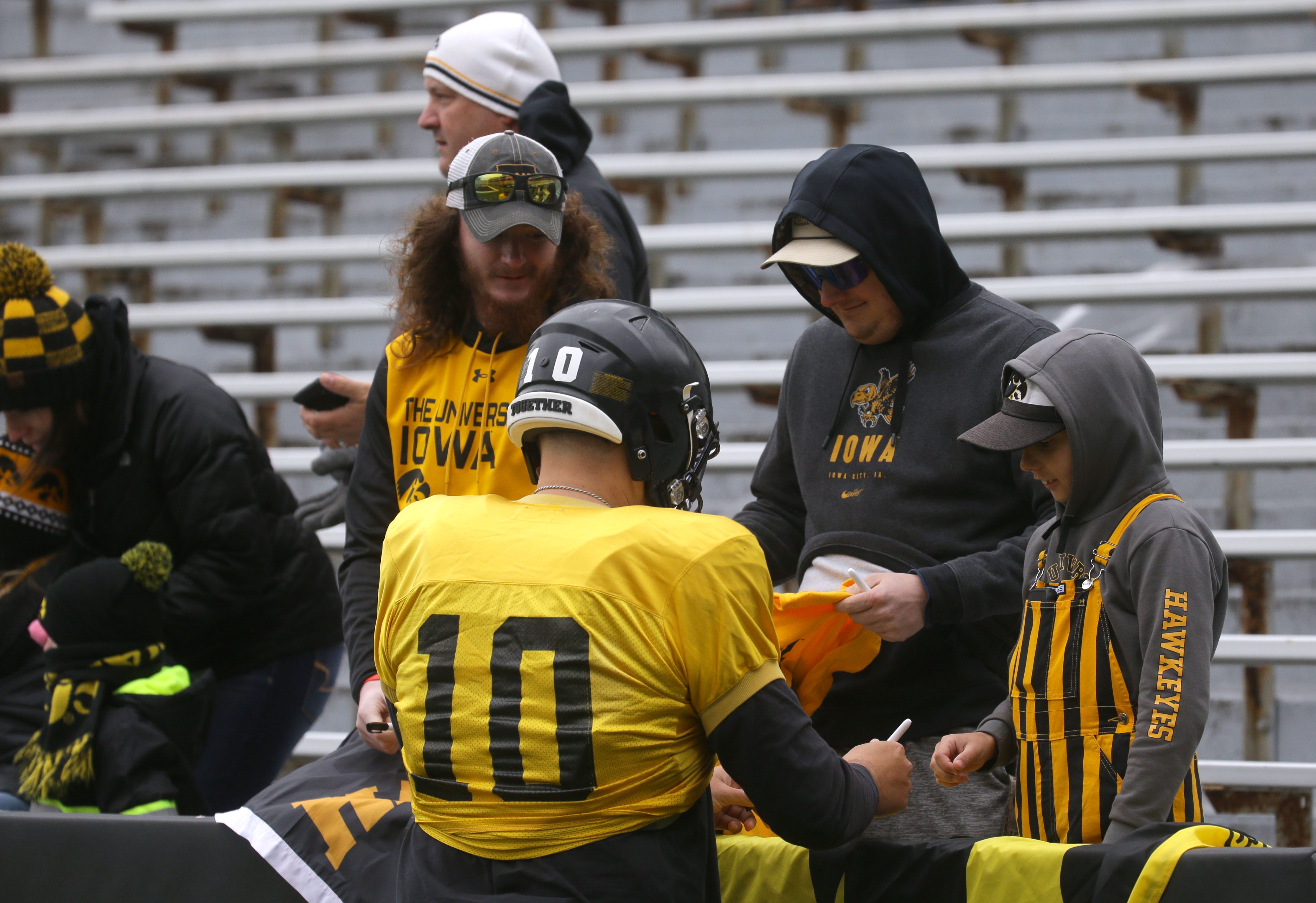 Iowa Hawkeyes quarterback Deacon Hill (10) signs autographs for fans during an open spring practice Saturday, April 20, 2024 at Kinnick Stadium in Iowa City, Iowa.