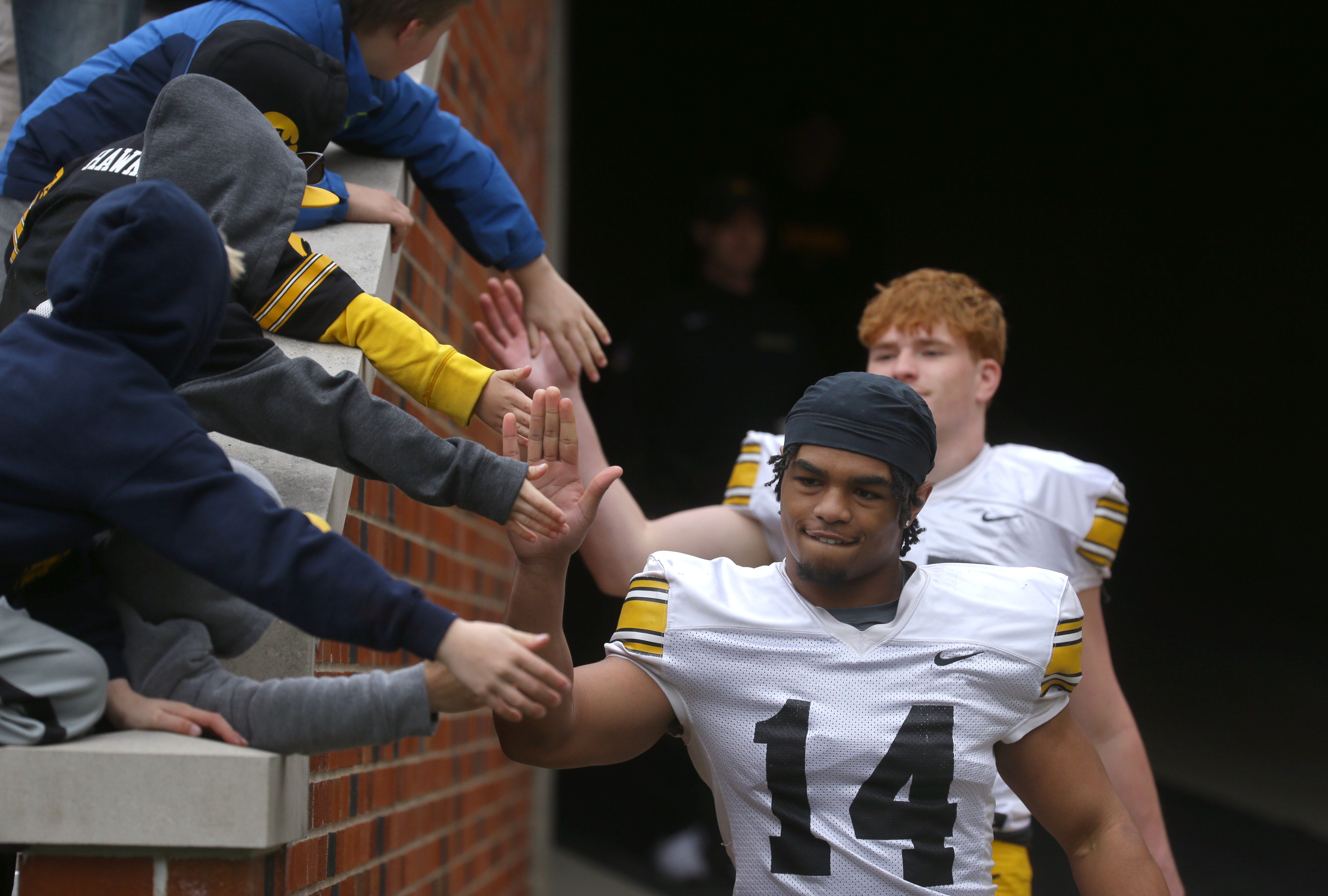 Iowa Hawkeyes defensive back Kahlil Tate high-fives fans while walking out of the tunnel during an open spring practice Saturday, April 20, 2024 at Kinnick Stadium in Iowa City, Iowa.