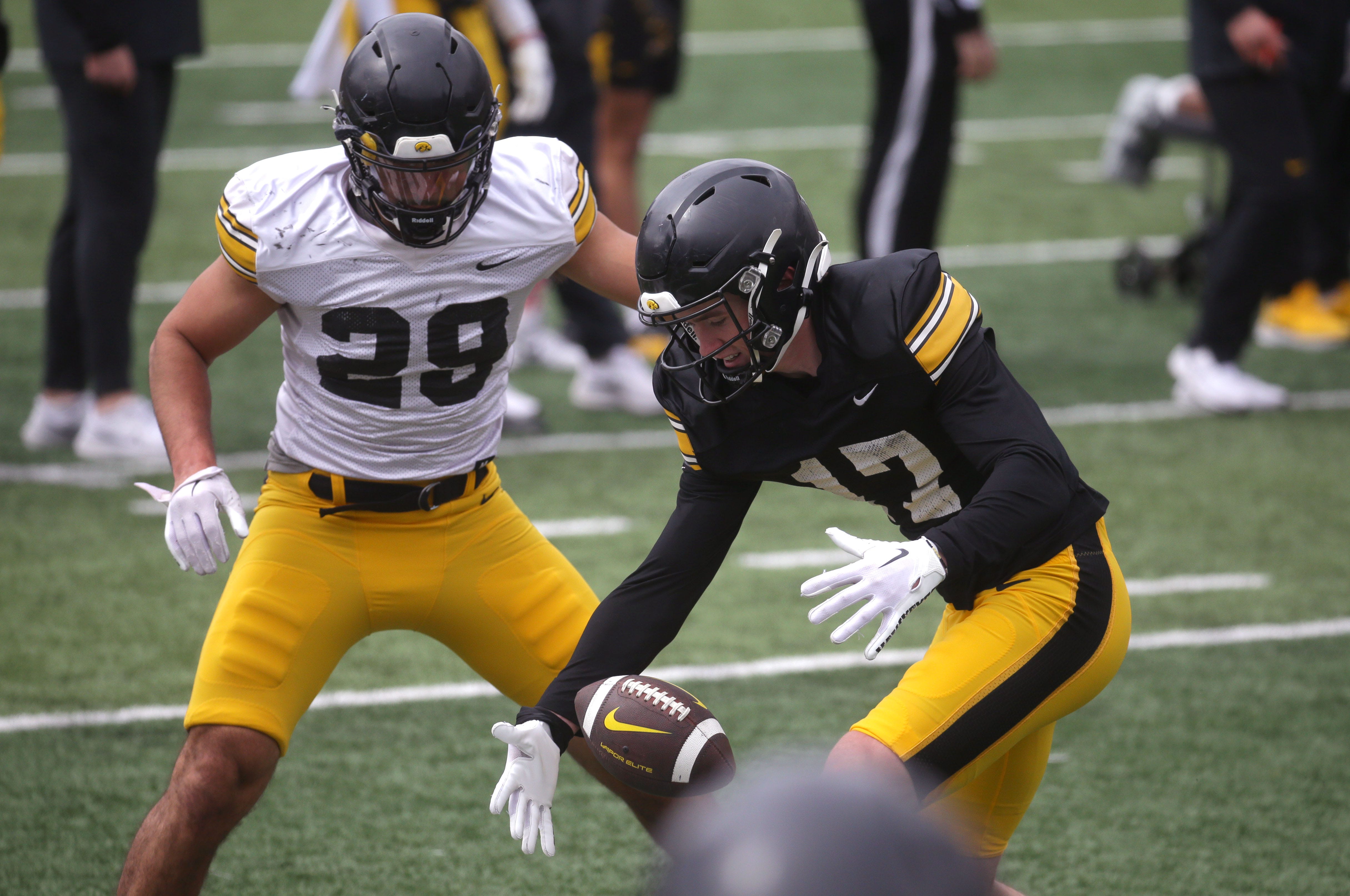 Iowa Hawkeyes wide receiver Alex Eichmann drops a pass as defensive back Sebastian Castro (29) defends during an open spring practice Saturday, April 20, 2024 at Kinnick Stadium in Iowa City, Iowa.