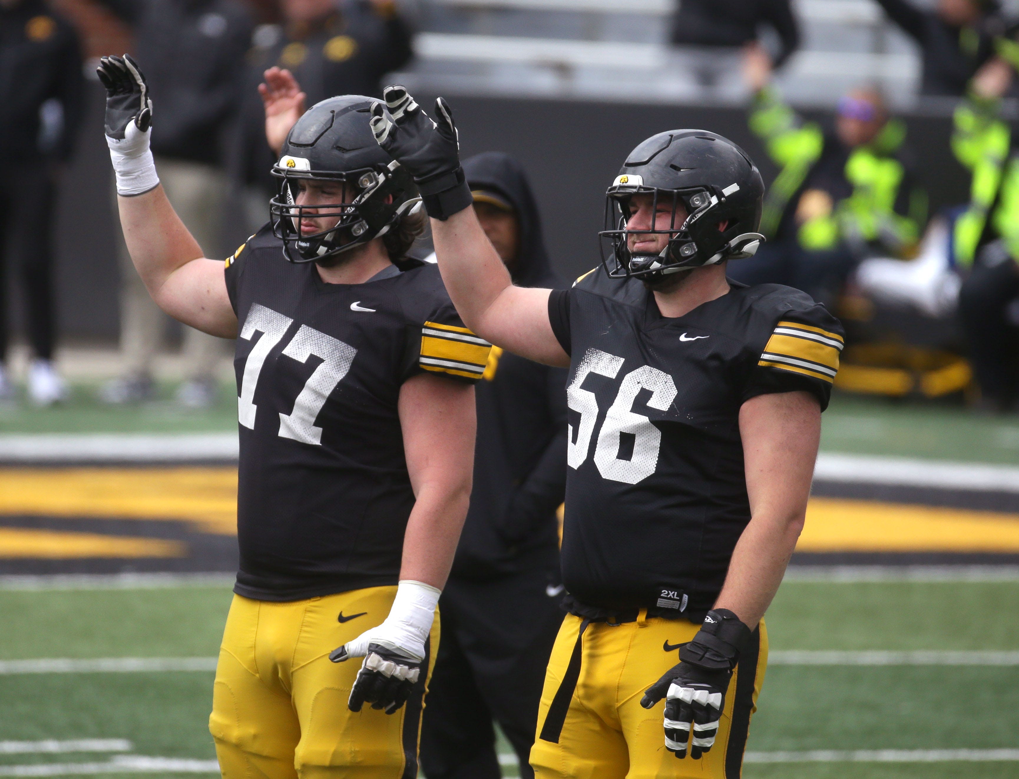 Iowa Hawkeyes offensive linemen Connor Colby (77) and Nick DeJong (56) wave to patients at the Stead Family Children’s Hospital during an open spring practice Saturday, April 20, 2024 at Kinnick Stadium in Iowa City, Iowa.