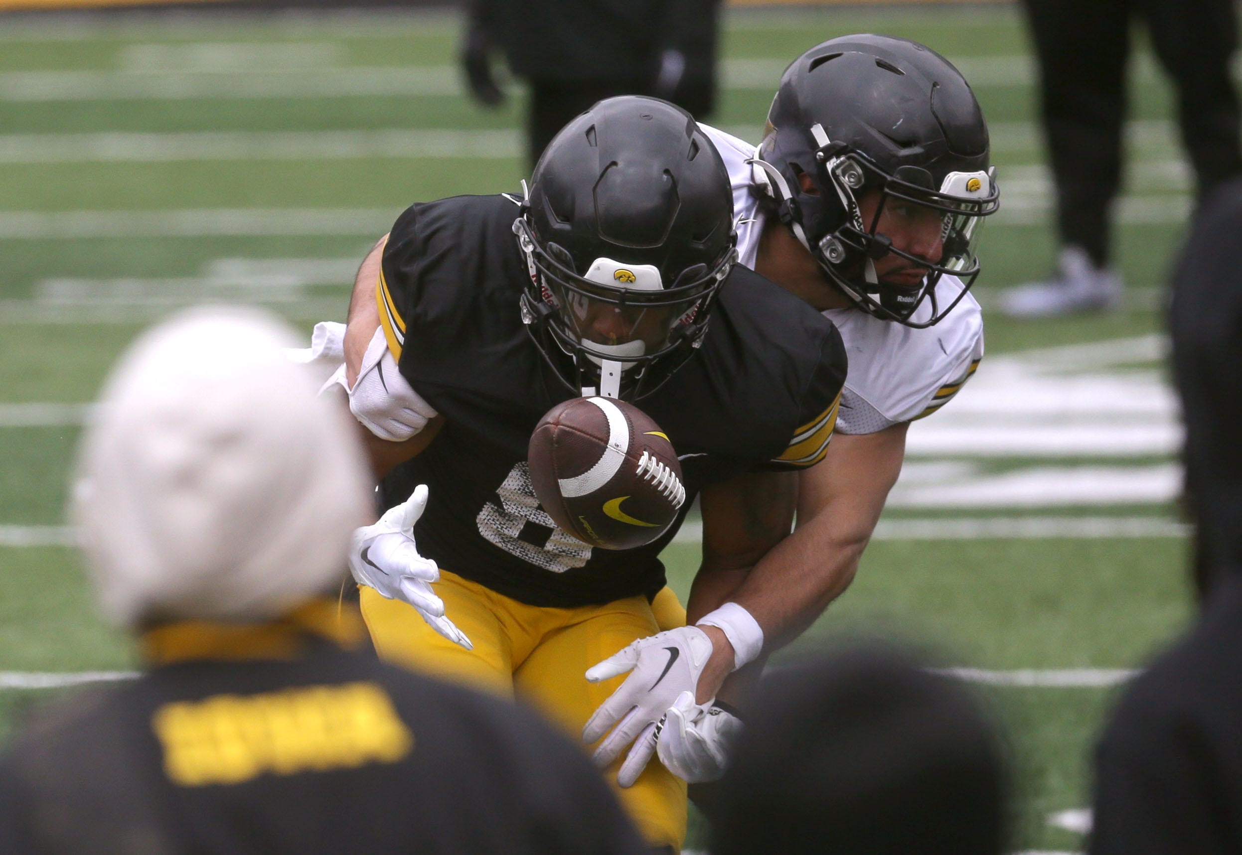 Iowa Hawkeyes running back Terrell Washington Jr. (8) bobbles the ball as defensive back Sebastian Castro (29) defends during an open spring practice Saturday, April 20, 2024 at Kinnick Stadium in Iowa City, Iowa.
