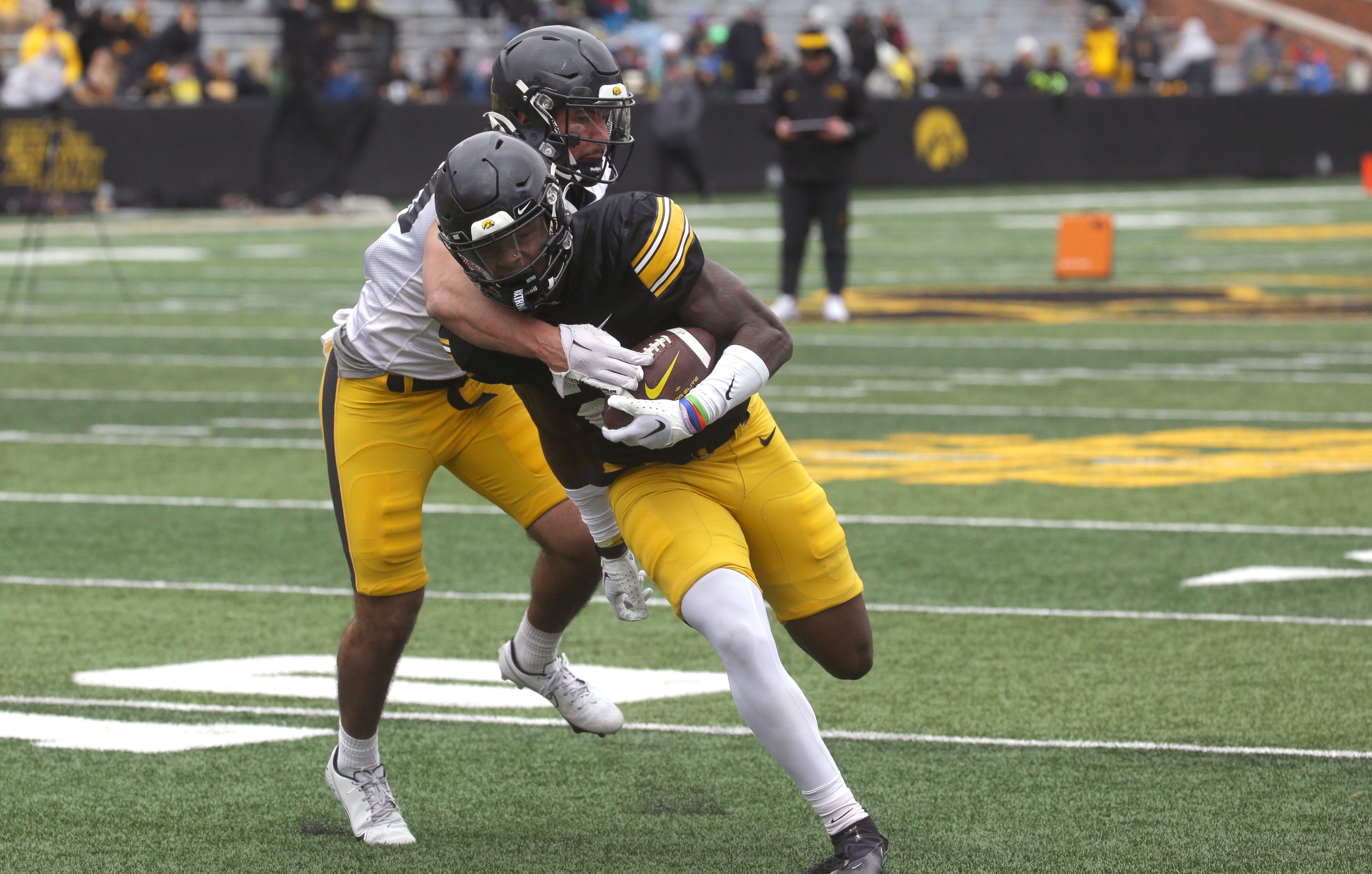 Iowa Hawkeyes defensive back Sebastian Castro (29) attempts to tackle running back Kaleb Johnson (2) during an open spring practice Saturday, April 20, 2024 at Kinnick Stadium in Iowa City, Iowa.