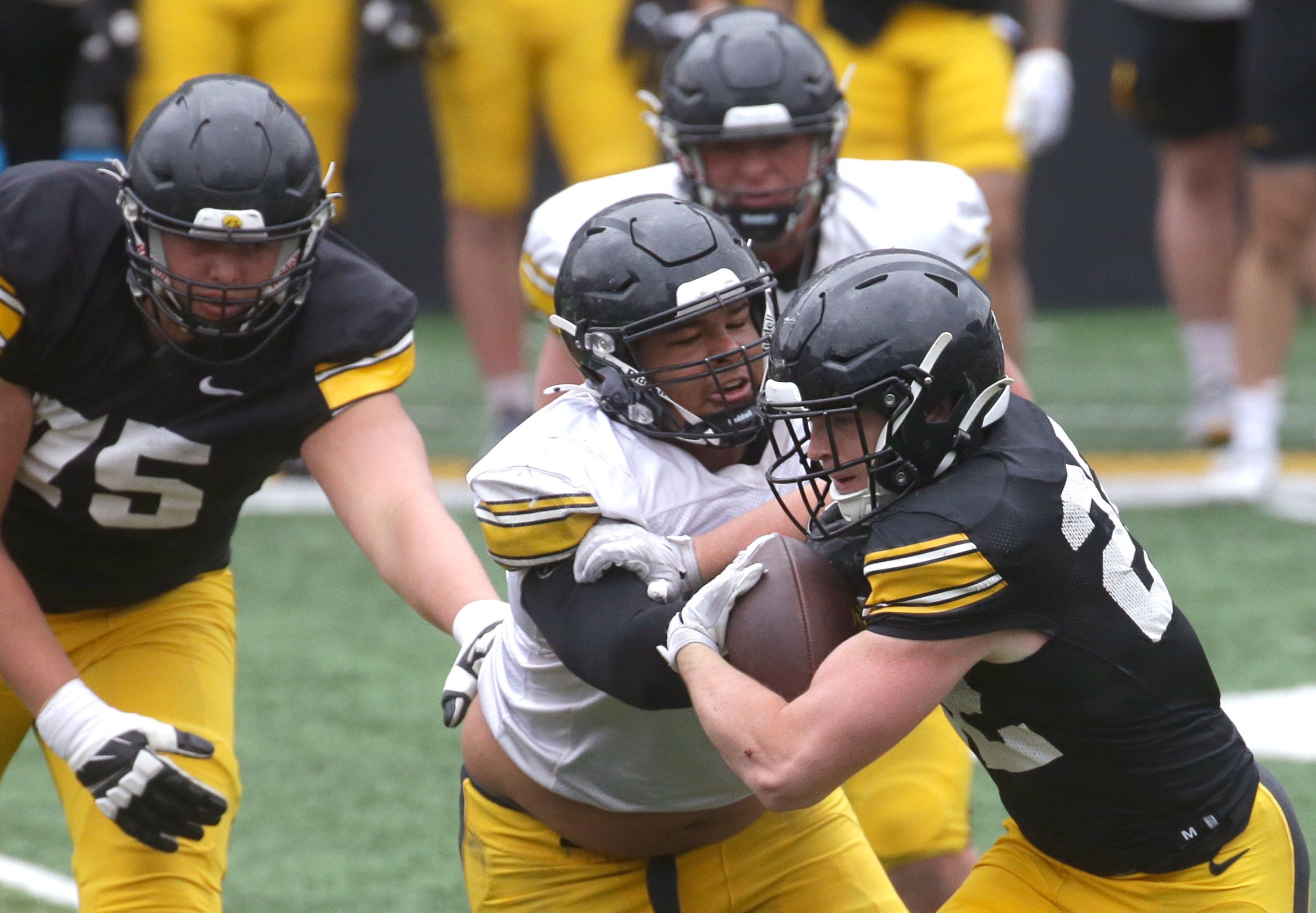 Iowa Hawkeyes runnign back Max White (22), right, runs the ball during an open spring practice Saturday, April 20, 2024 at Kinnick Stadium in Iowa City, Iowa.
