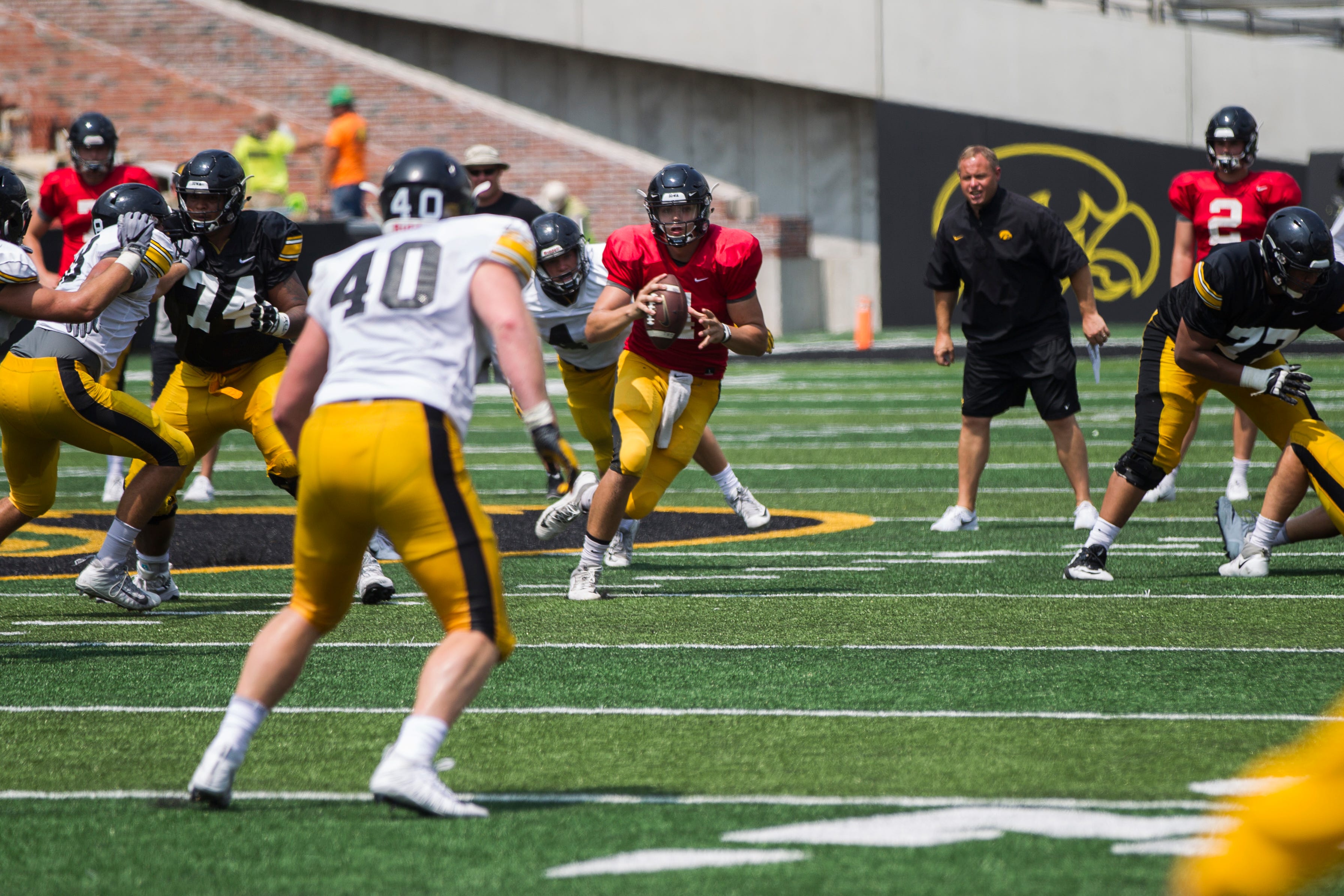Iowa quarterback Nate Stanley rolls out of the pocket  during a Kids Day practice on Saturday, Aug. 11, 2018, at Kinnick Stadium in Iowa City.