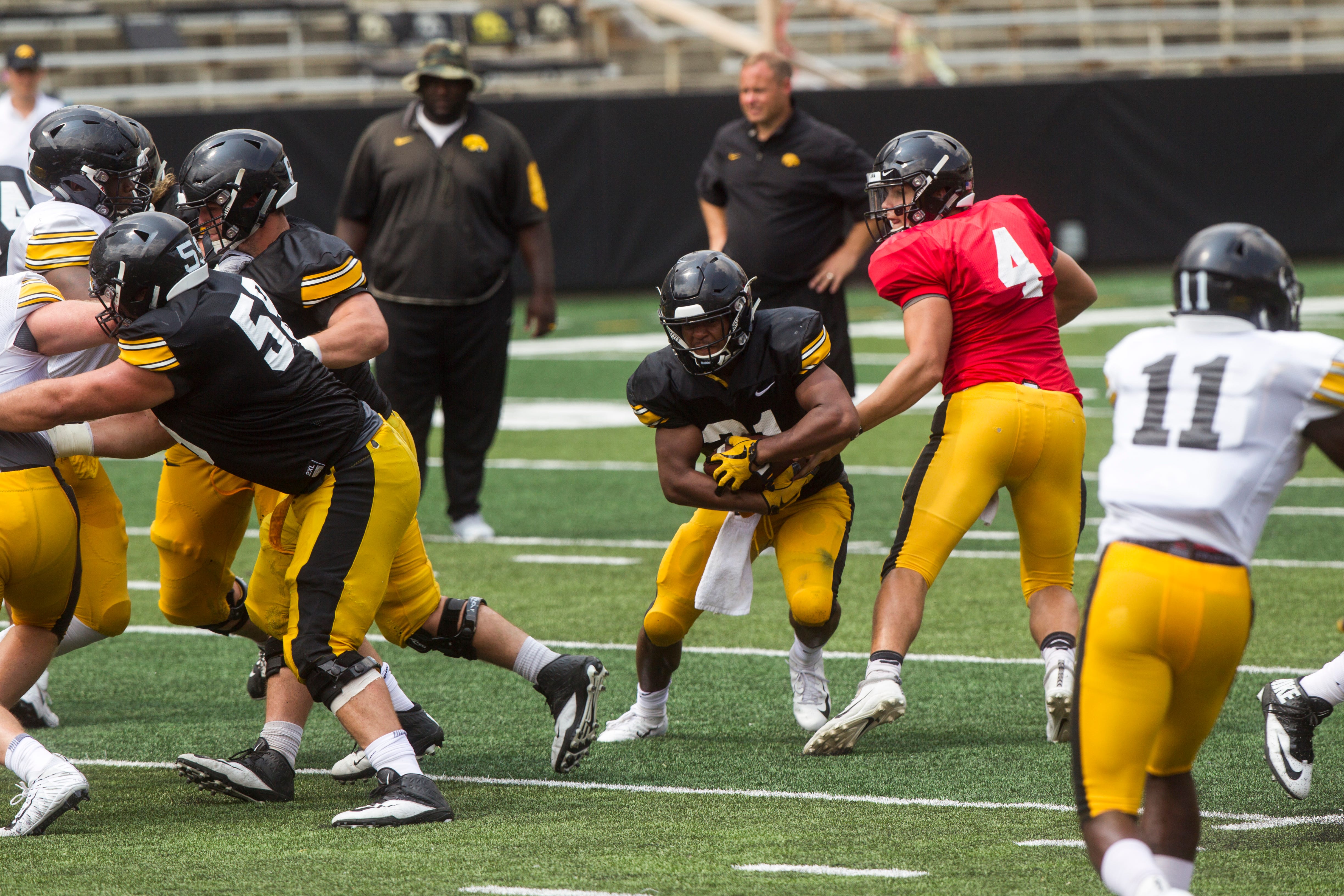 Iowa running back Ivory Kelly-Martin receives a handoff from quarterback Nate Stanley during a Kids Day practice on Saturday, Aug. 11, 2018, at Kinnick Stadium in Iowa City.