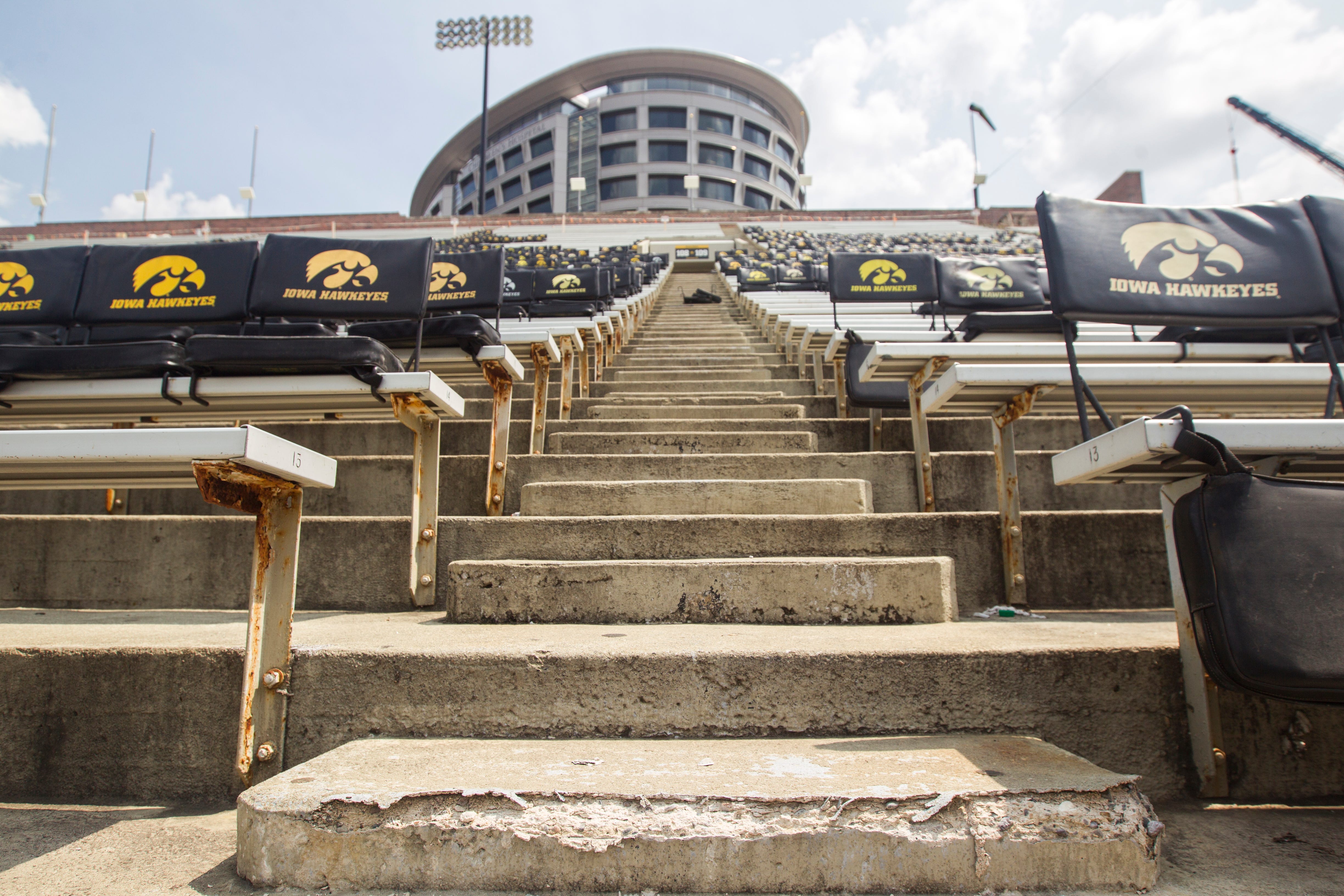 Cement deteriorates along a staircase in the east stands during a Kids Day practice on Saturday, Aug. 11, 2018, at Kinnick Stadium in Iowa City.