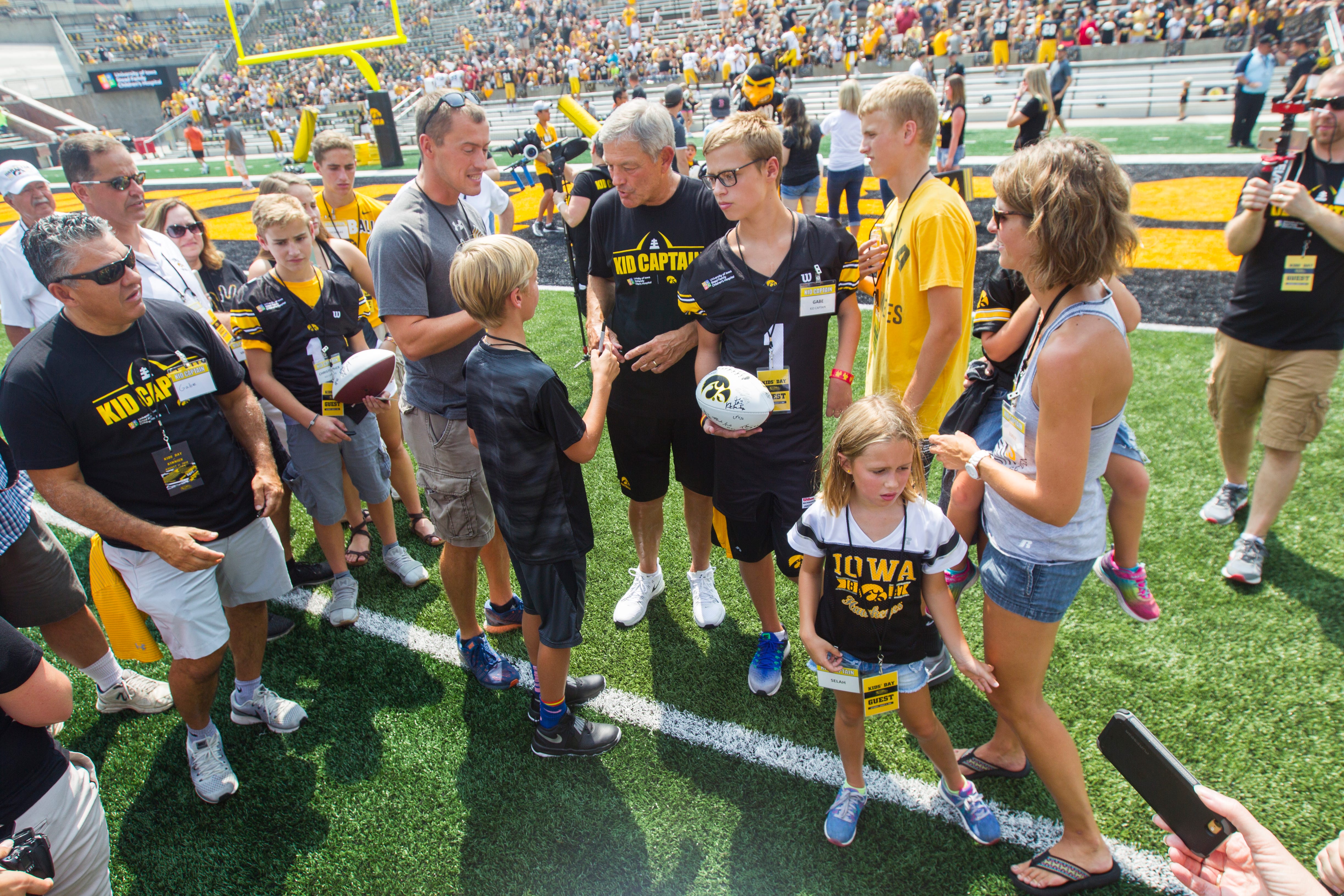 Iowa head coach Kirk Ferentz meets with the families of this years Kid Captains during a Kids Day practice on Saturday, Aug. 11, 2018, at Kinnick Stadium in Iowa City.