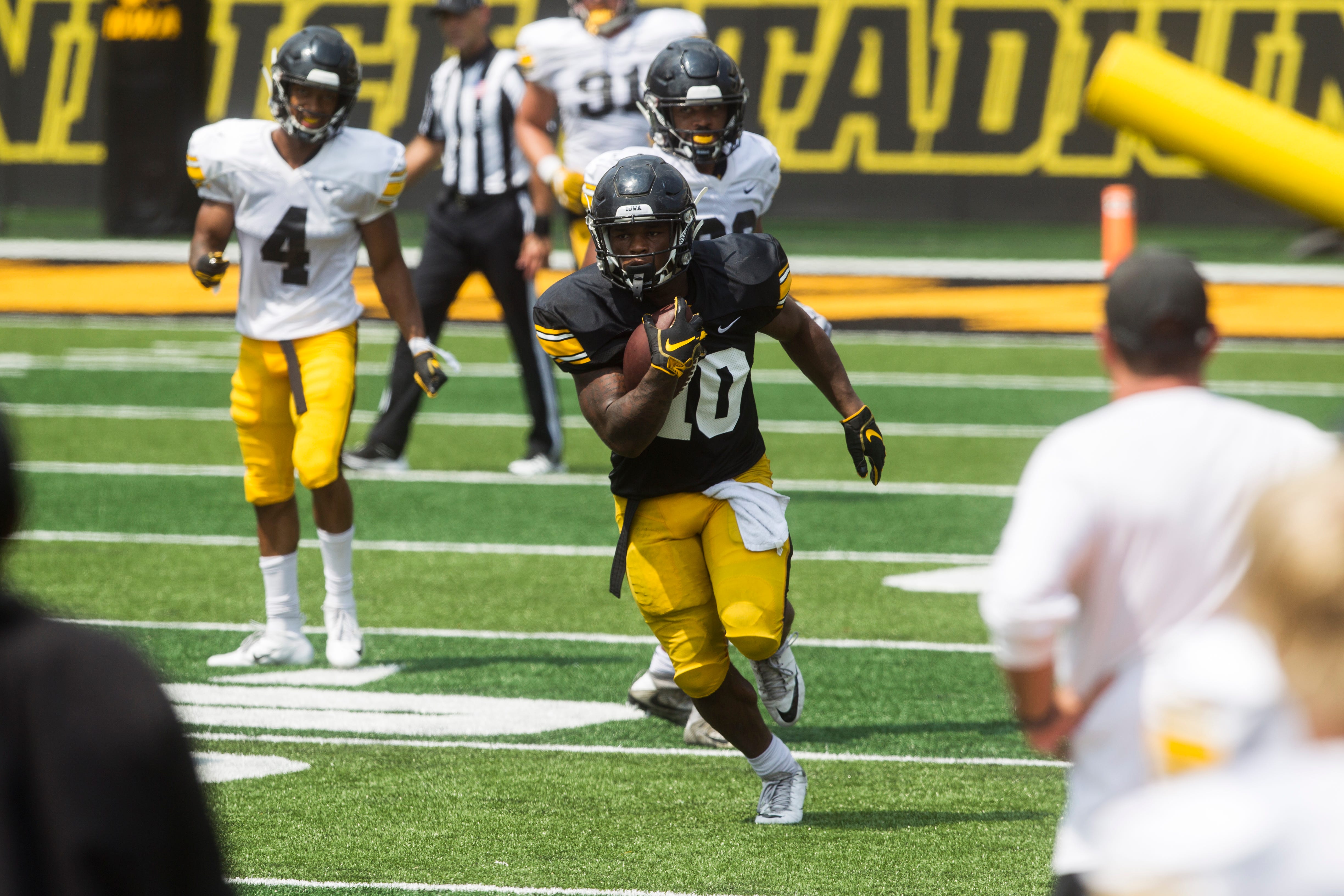 Iowa running back Mekhi Sargent rushes during a Kids Day practice on Saturday, Aug. 11, 2018, at Kinnick Stadium in Iowa City.