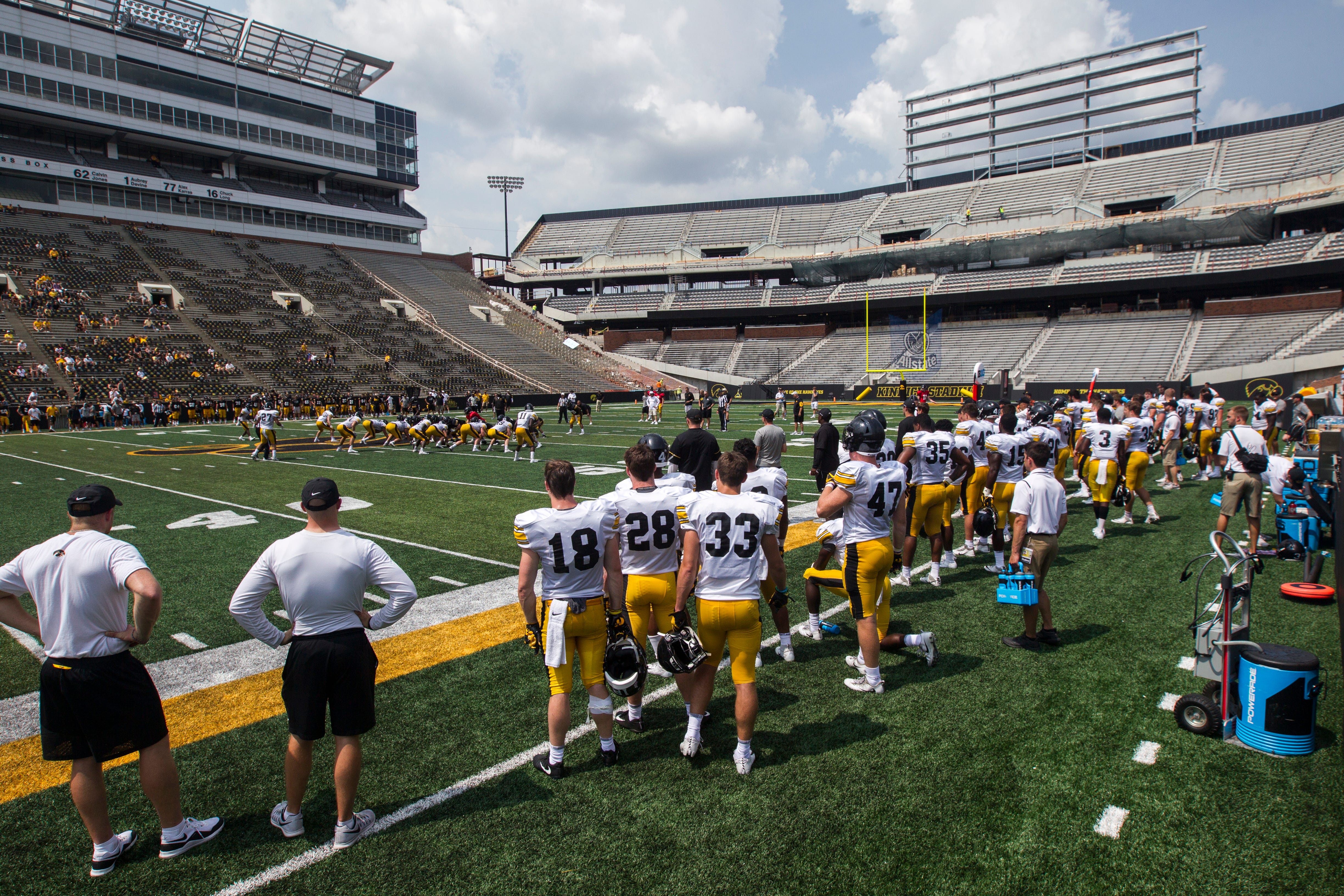 Iowa's defensive stands on the sidelines while construction continues in the north endzone during a Kids Day practice on Saturday, Aug. 11, 2018, at Kinnick Stadium in Iowa City.