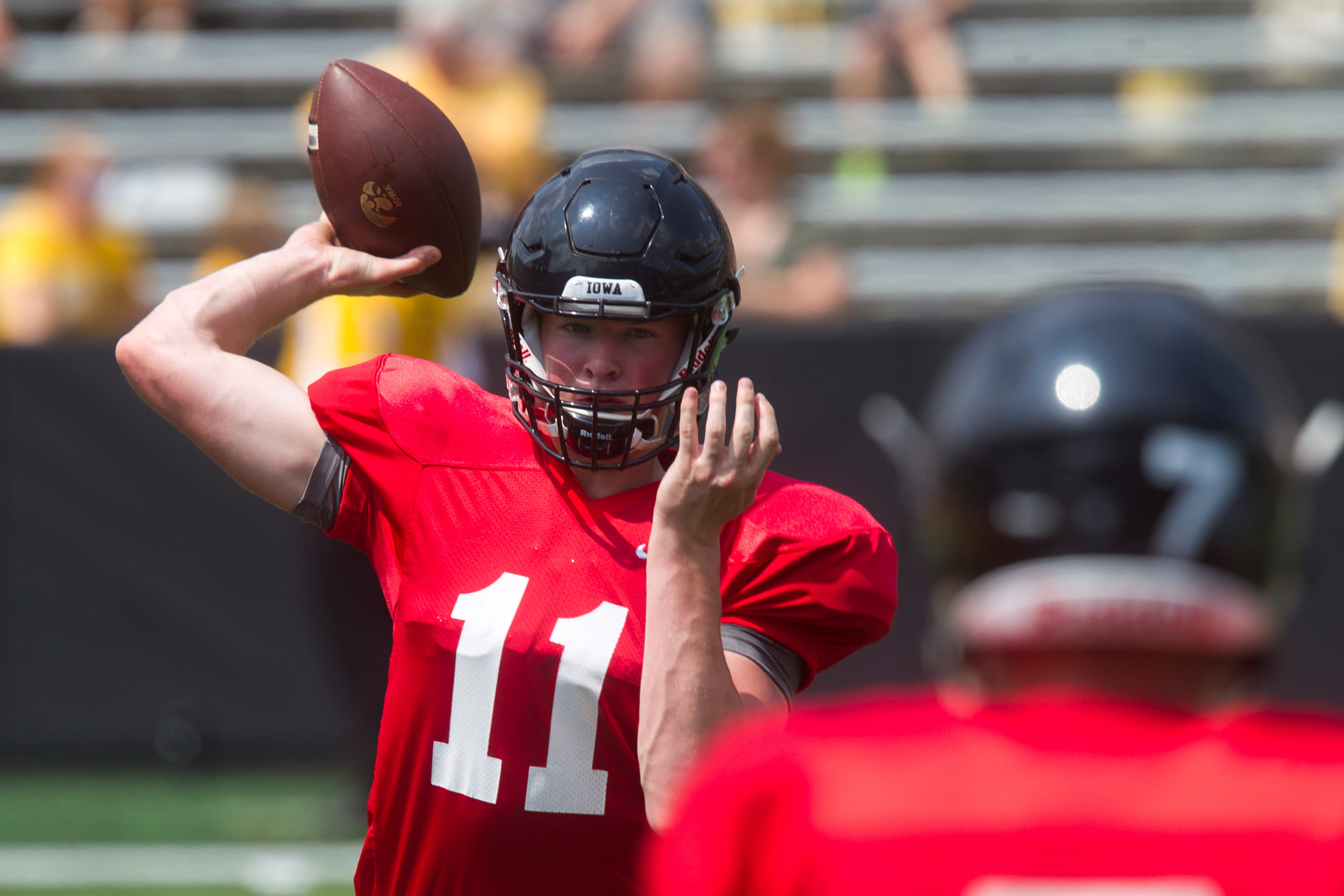 Iowa quarterback Connor Kapisak throws a pass to teammate Spencer Petras while they warm up during a Kids Day practice on Saturday, Aug. 11, 2018, at Kinnick Stadium in Iowa City.