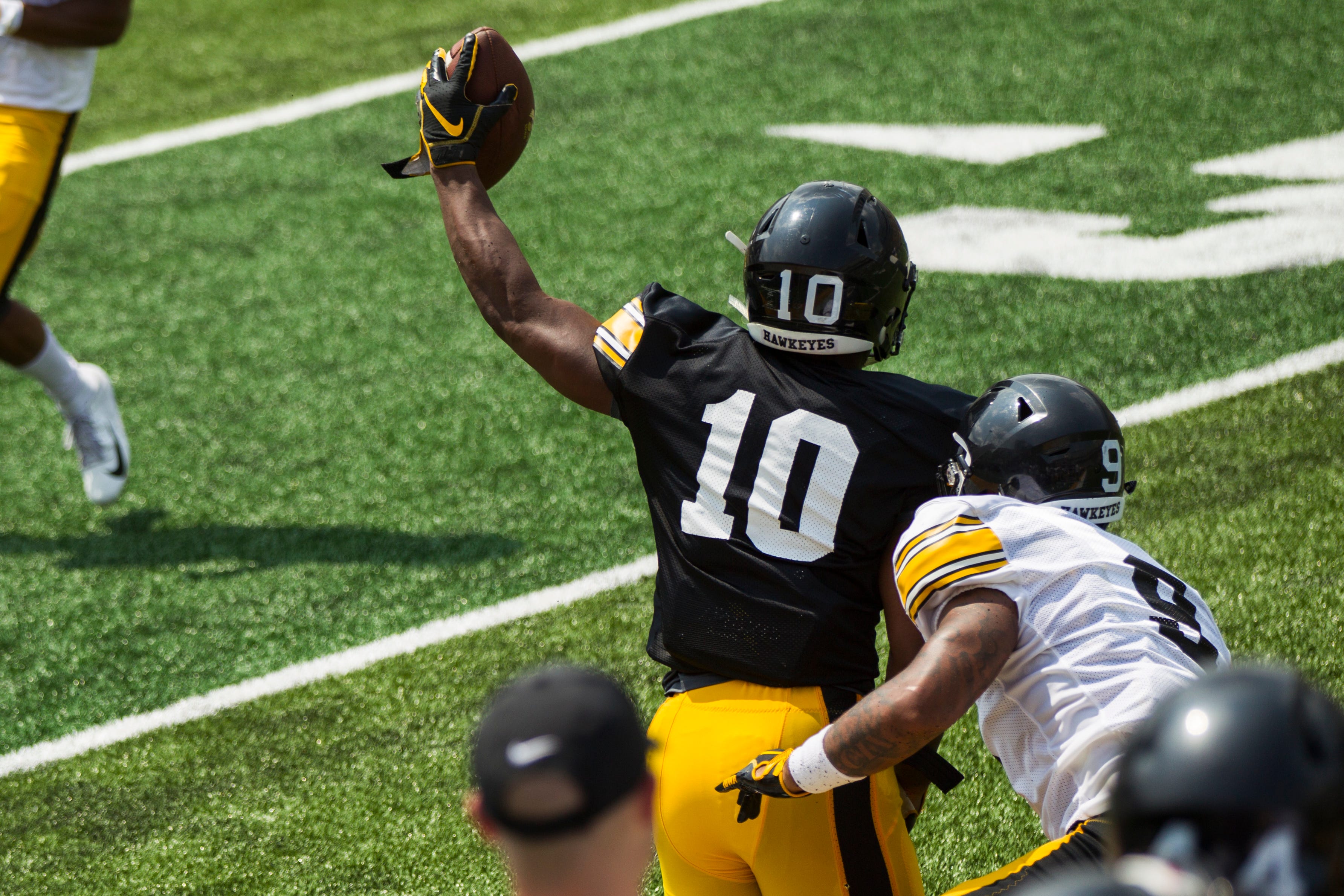 Iowa running back Mekhi Sargent holds a ball in the air after pulling a reception during a Kids Day practice on Saturday, Aug. 11, 2018, at Kinnick Stadium in Iowa City.