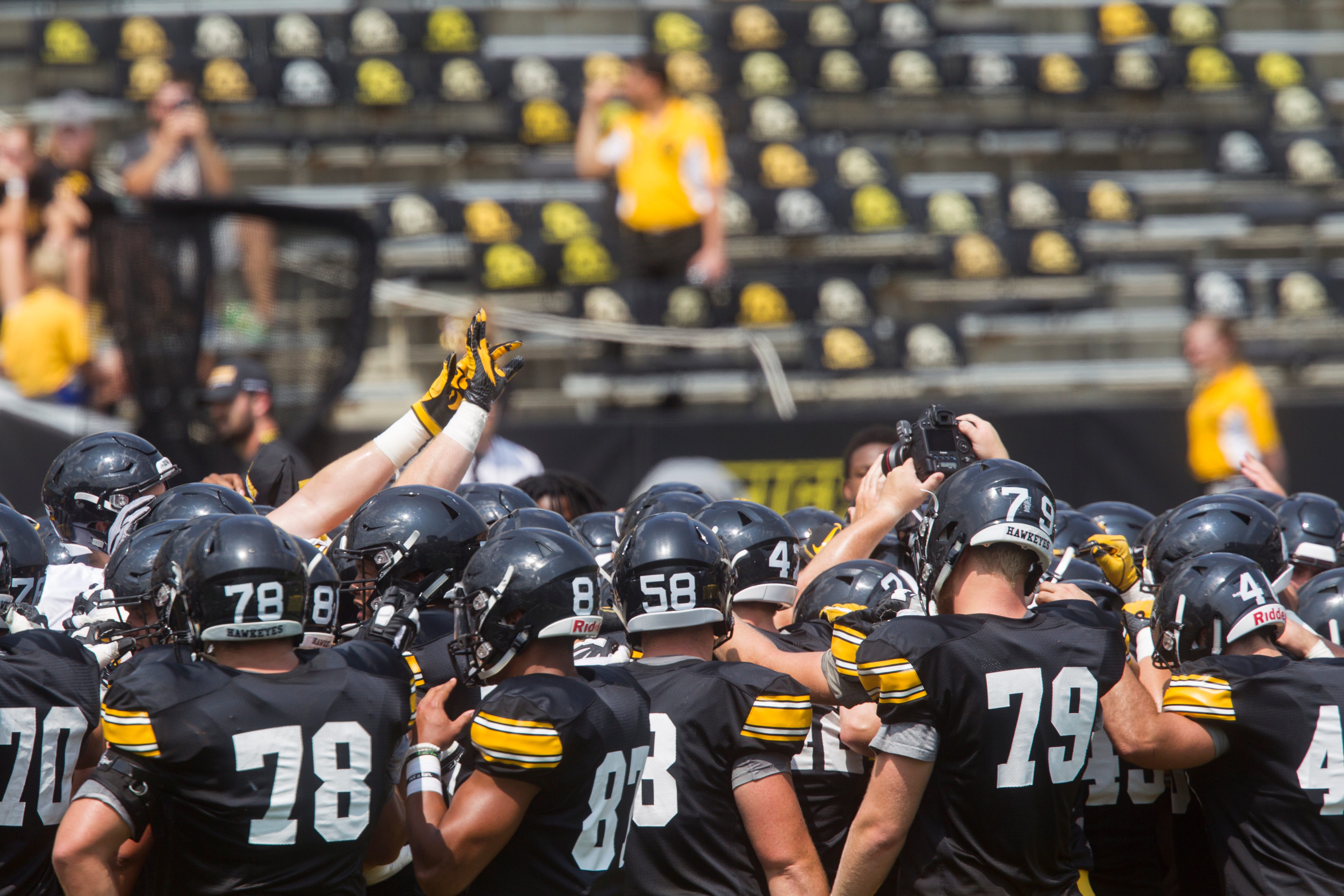 Iowa players huddle during a Kids Day practice on Saturday, Aug. 11, 2018, at Kinnick Stadium in Iowa City.