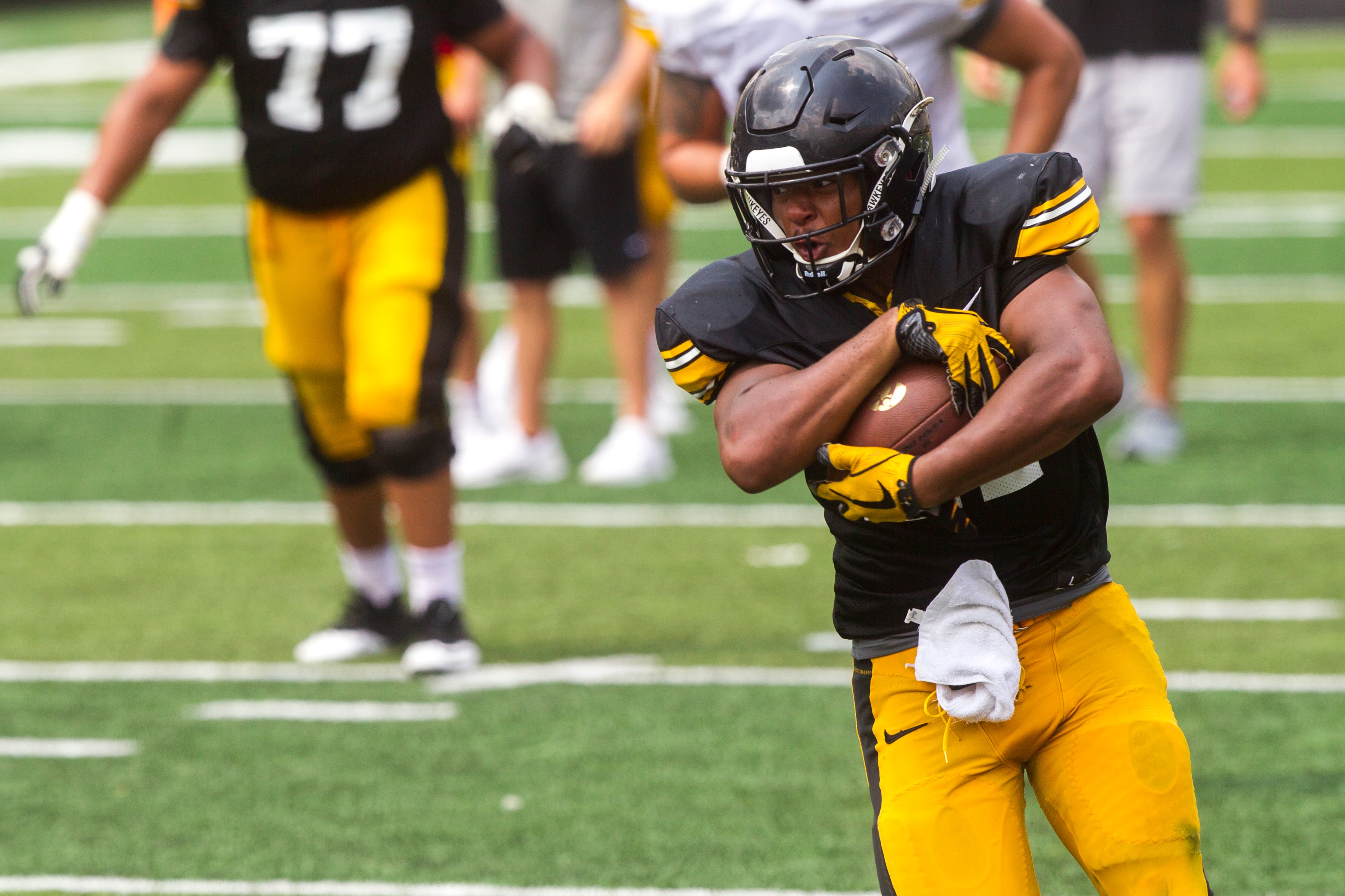 Iowa running back Ivory Kelly-Martin protects the ball during a Kids Day practice on Saturday, Aug. 11, 2018, at Kinnick Stadium in Iowa City.