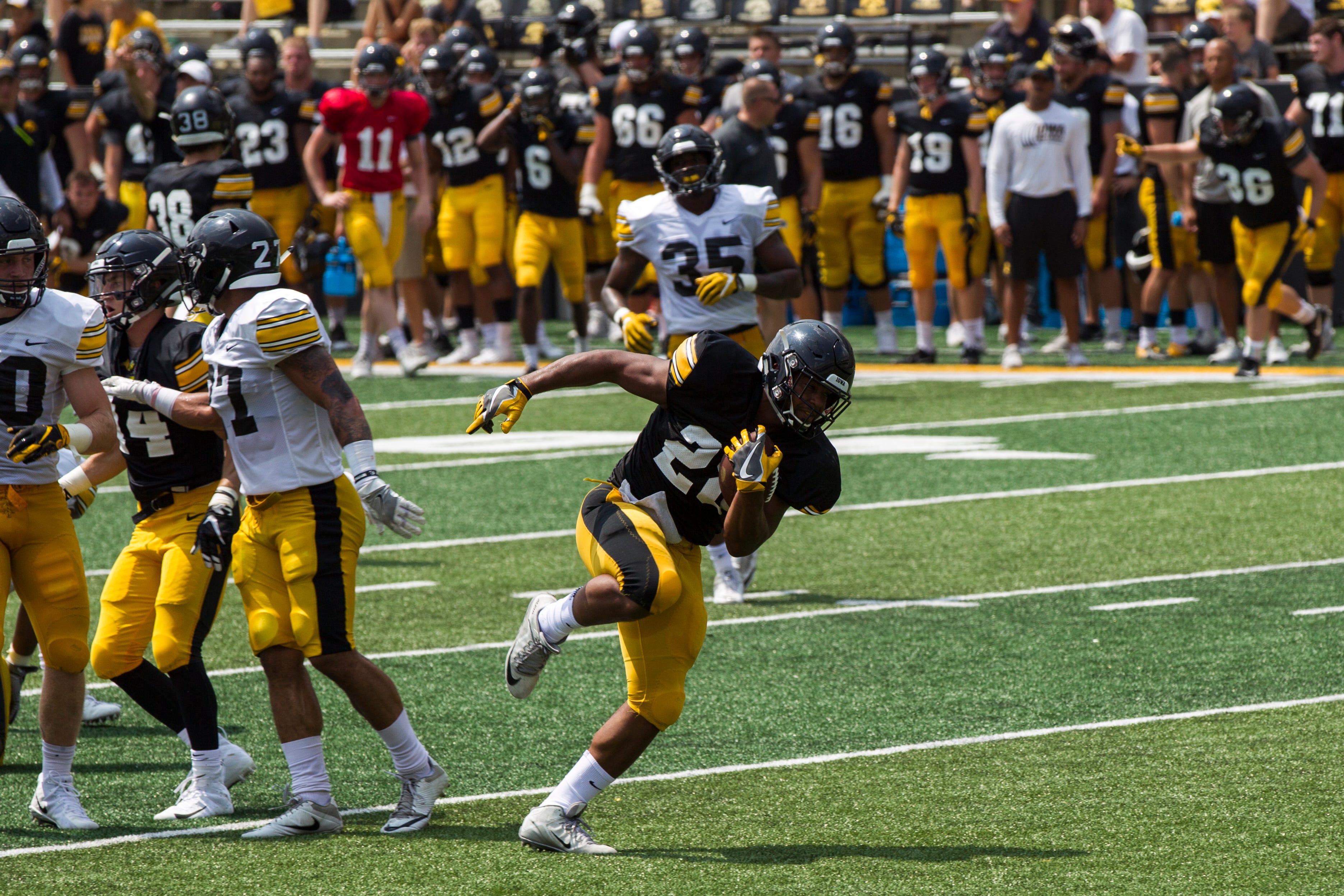 Iowa running back Toren Young sheds a tackle during a Kids Day practice on Saturday, Aug. 11, 2018, at Kinnick Stadium in Iowa City.