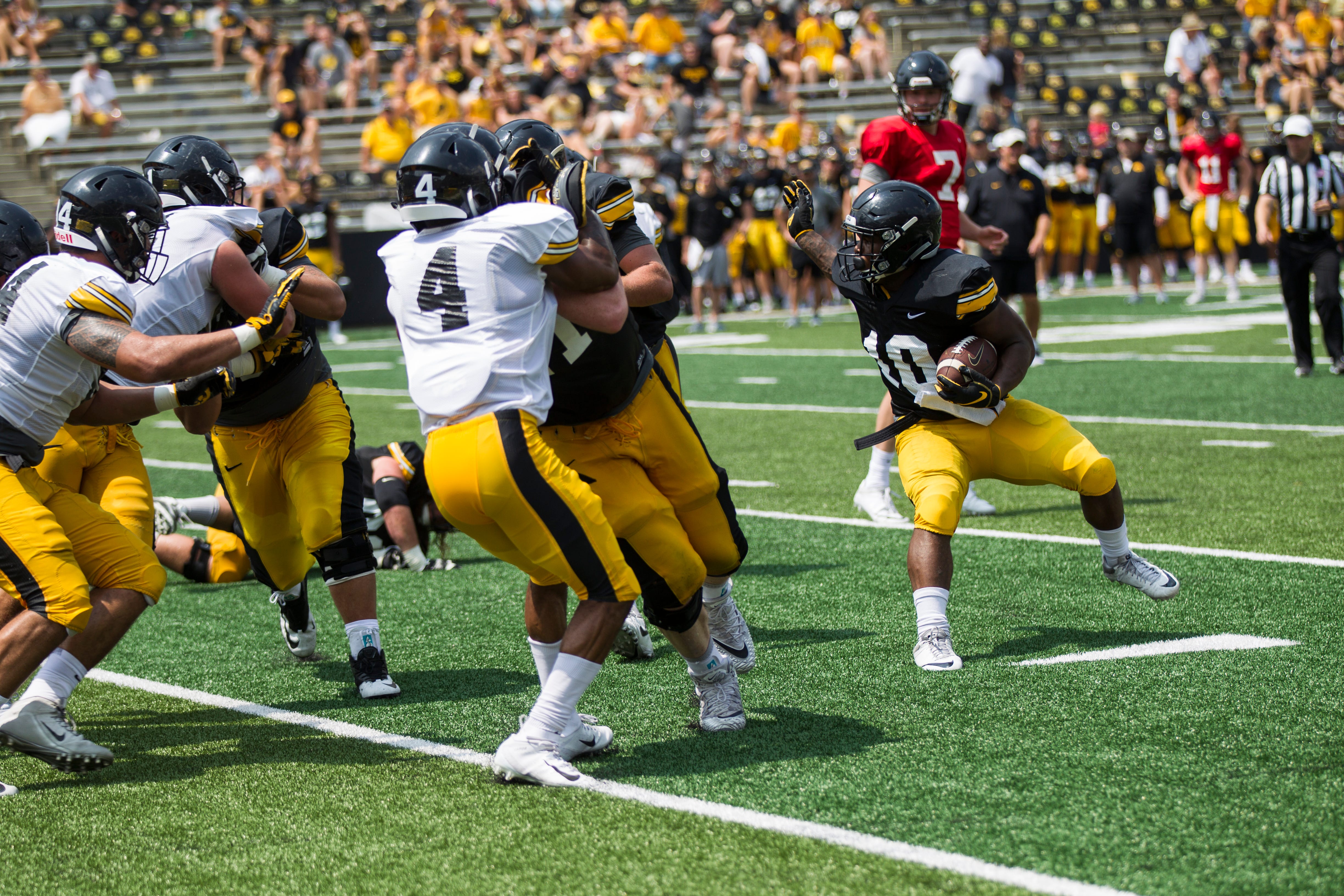 Iowa running back Mekhi Sargent jukes defenders during a Kids Day practice on Saturday, Aug. 11, 2018, at Kinnick Stadium in Iowa City.