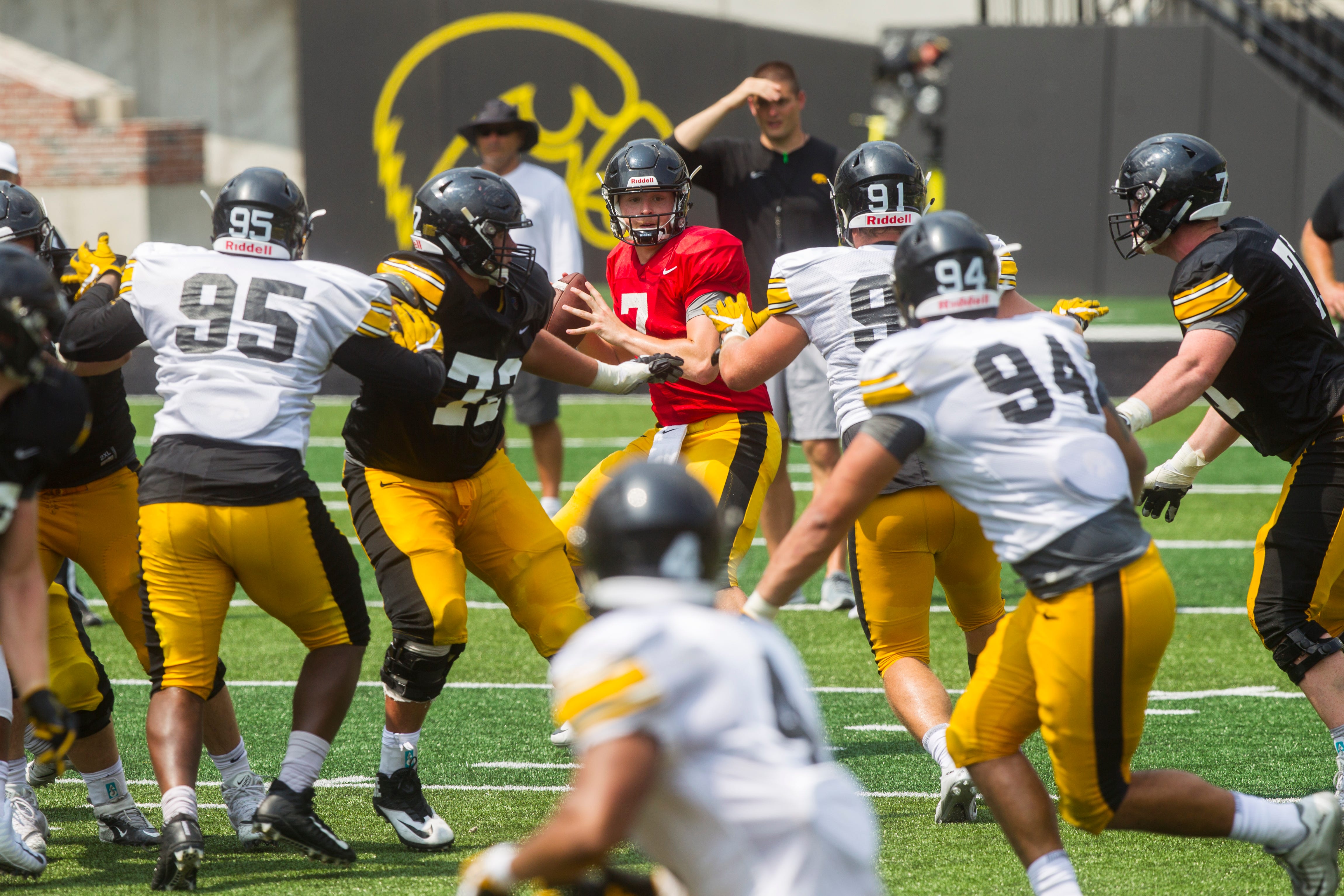 Iowa quarterback Spencer Petras looks for a receiver while defensive linemen Cedrick Lattimore and Brady Reiff apply pressure during a Kids Day practice on Saturday, Aug. 11, 2018, at Kinnick Stadium in Iowa City.