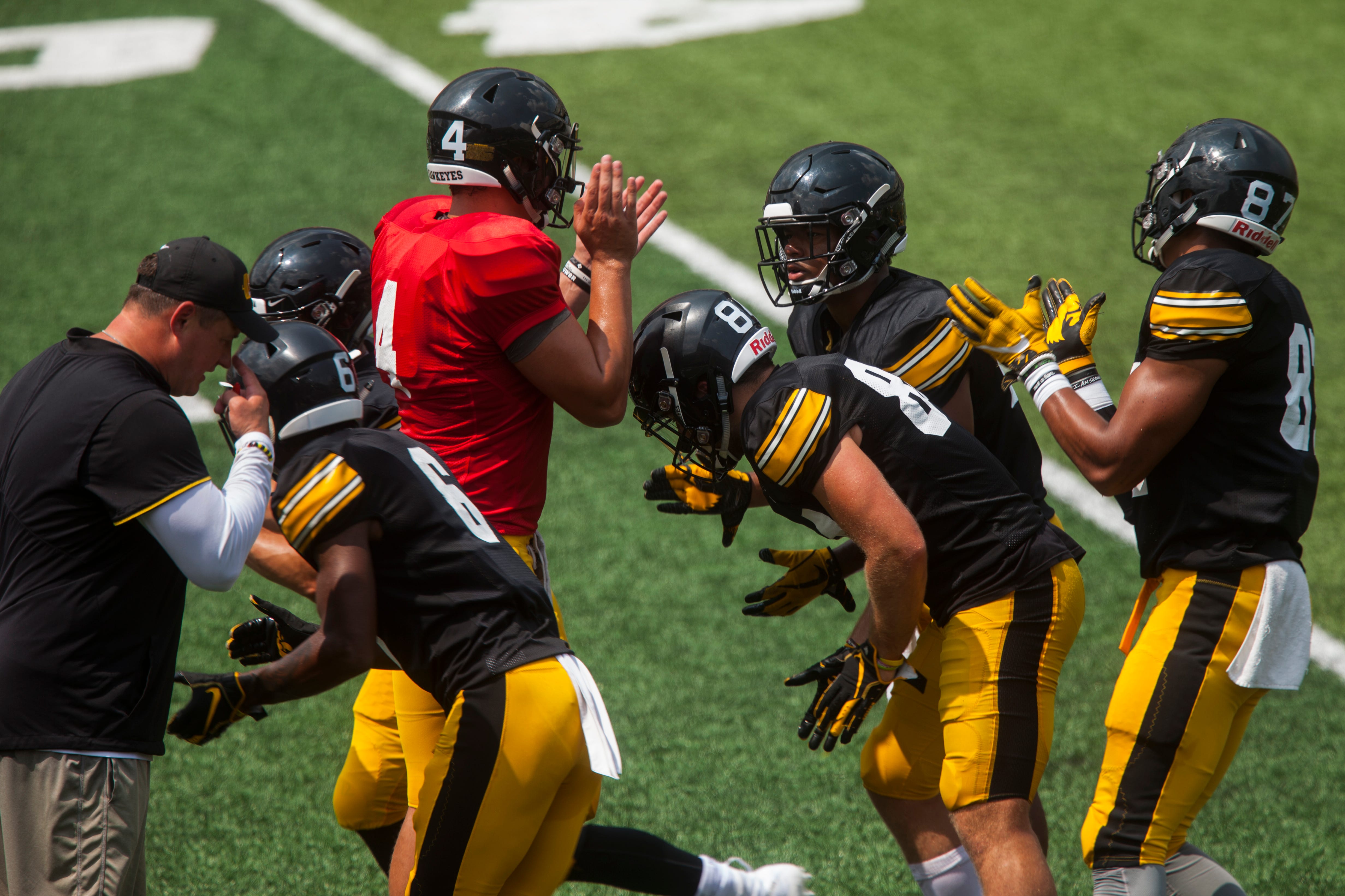 Iowa quarterback Nate Stanley heads out of the huddle after getting a call from offensive coordinator Brian Ferentz during a Kids Day practice on Saturday, Aug. 11, 2018, at Kinnick Stadium in Iowa City.