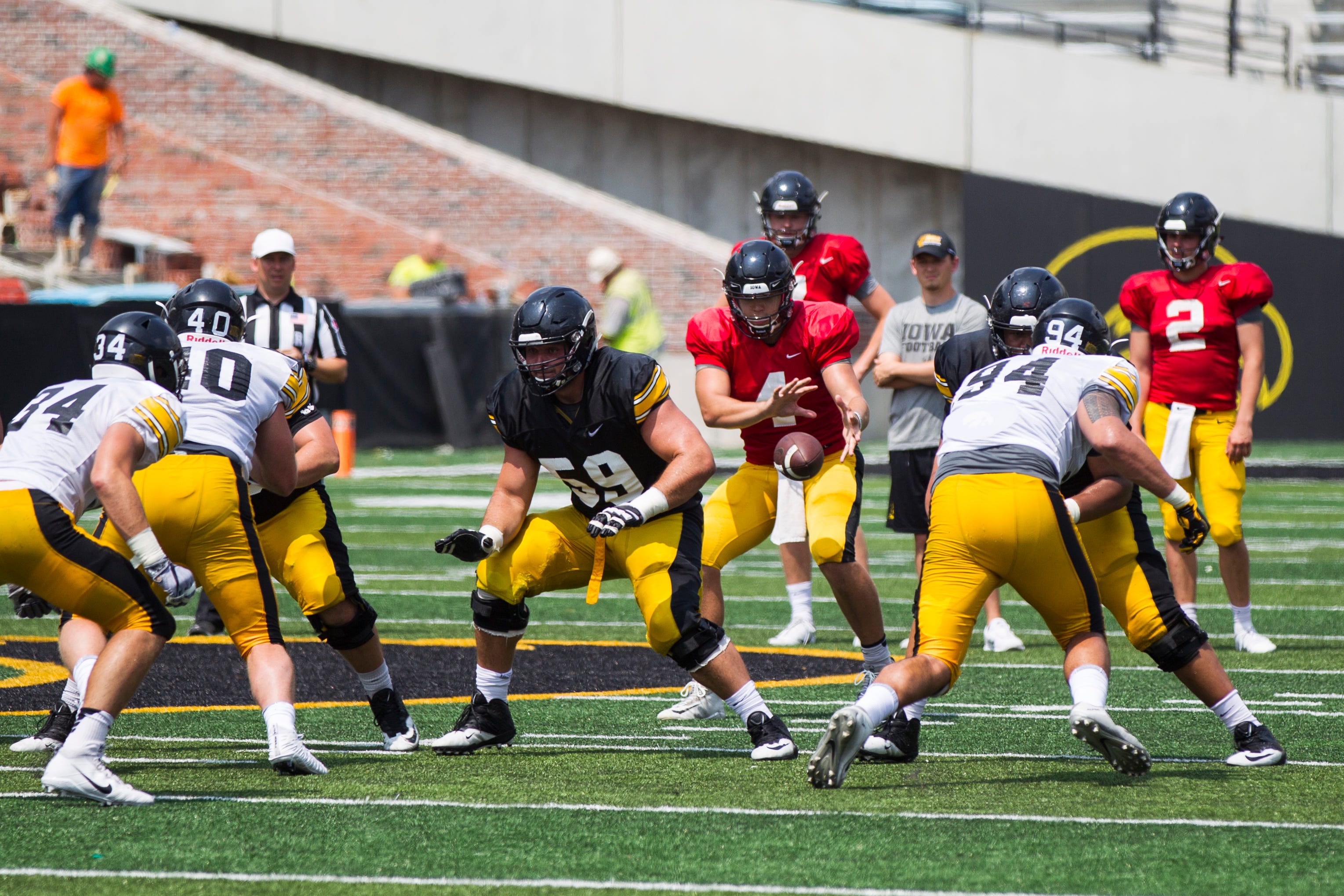 Iowa quarterback Nate Stanley catches a snap from offensive lineman Ross Reynolds during a Kids Day practice on Saturday, Aug. 11, 2018, at Kinnick Stadium in Iowa City.