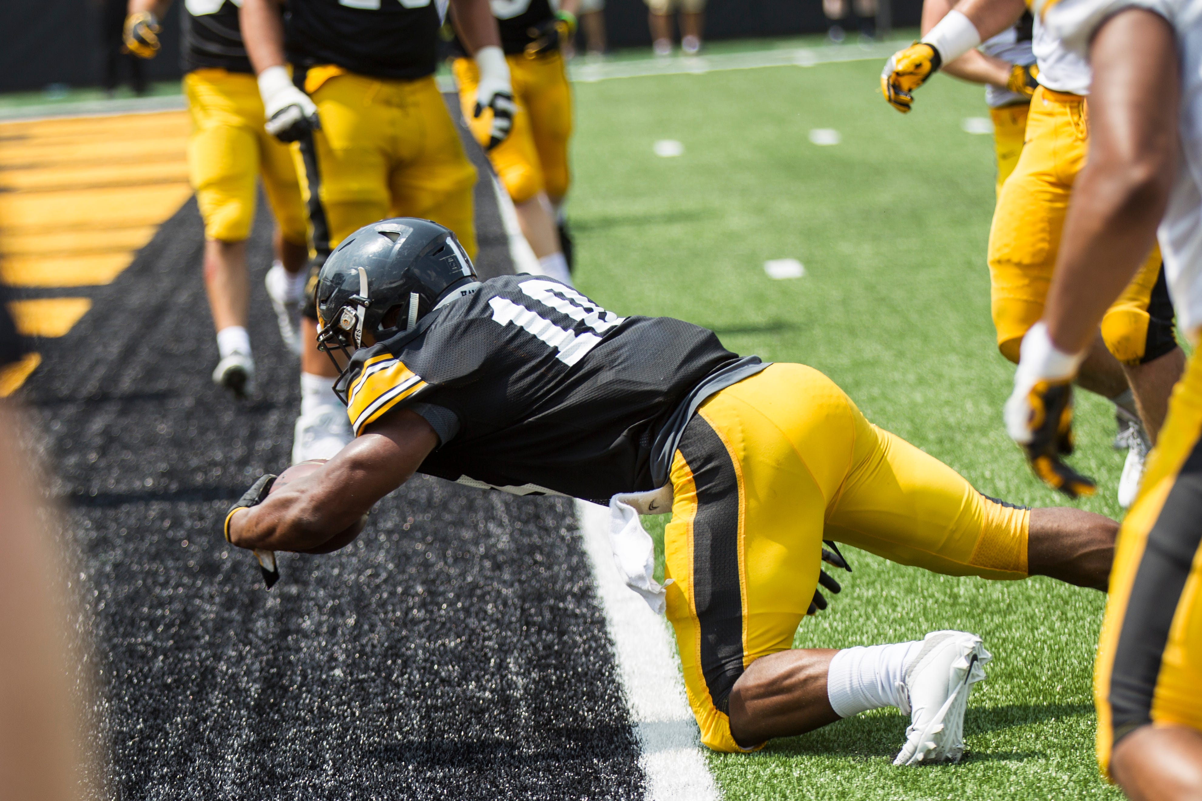 Iowa running back Mekhi Sargent dives into the end zone for a touchdown during a Kids Day practice on Saturday, Aug. 11, 2018, at Kinnick Stadium in Iowa City.